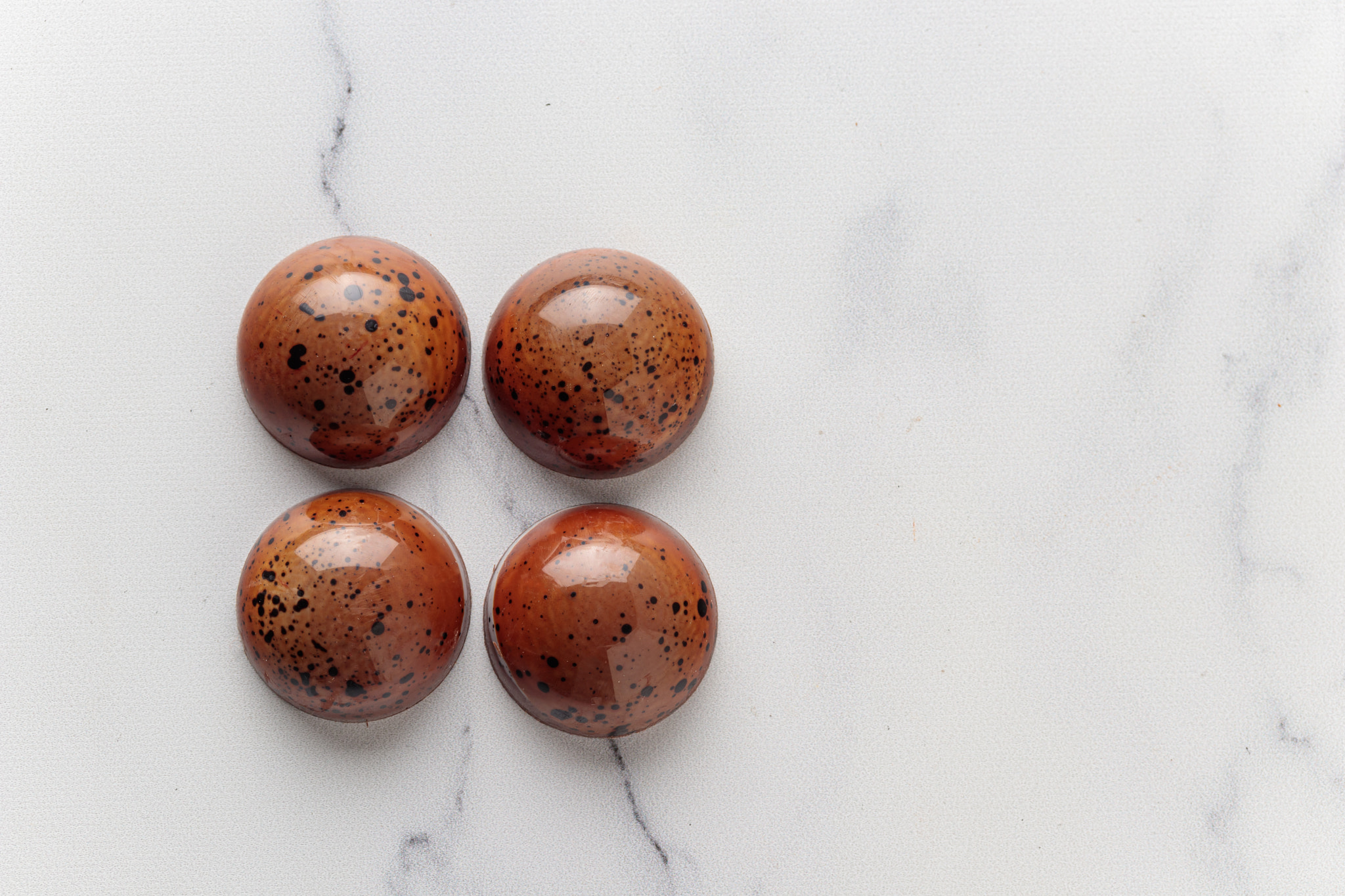 Assortment of painted handcrafted chocolate bonbons. Delicious dessert