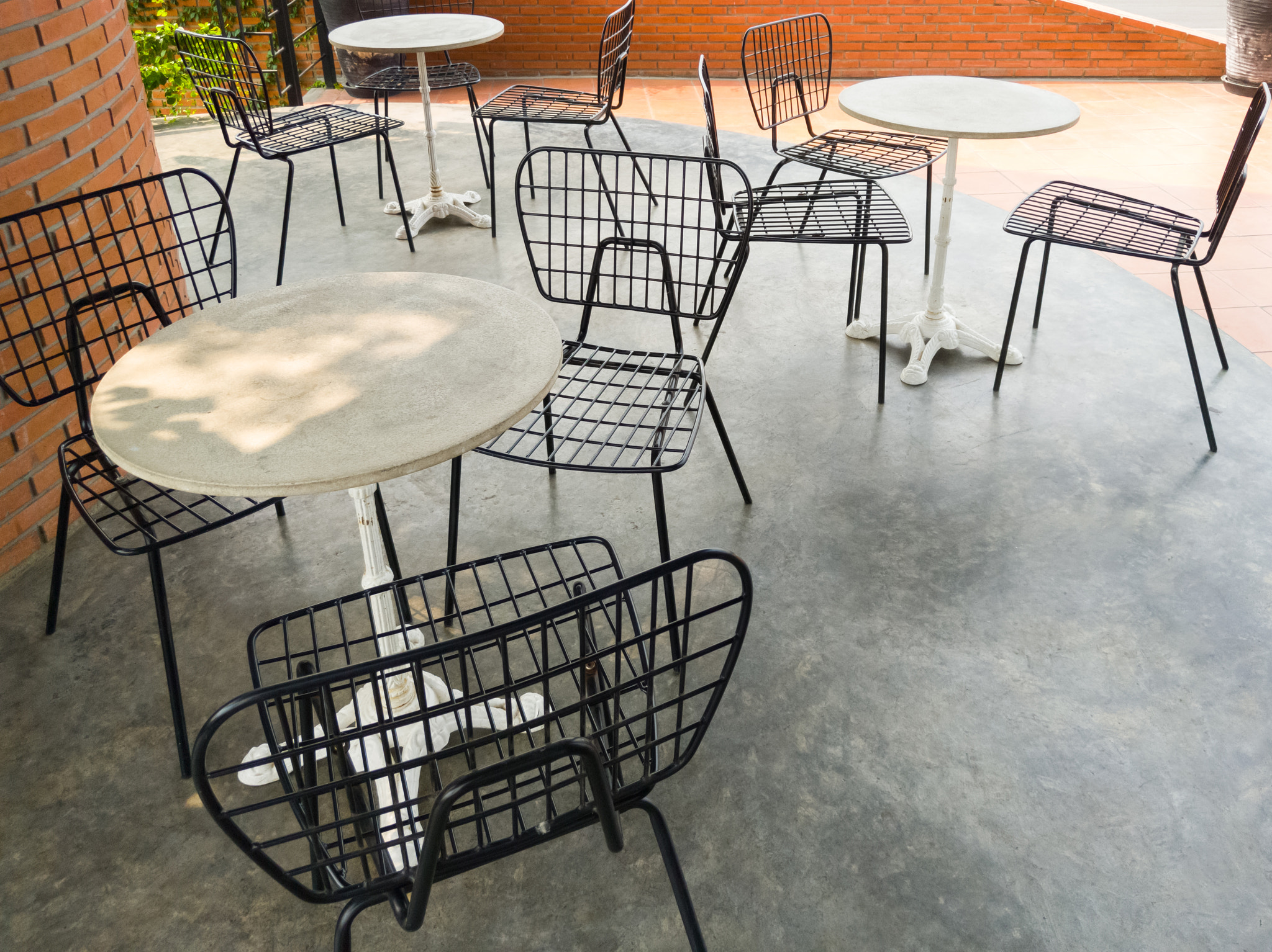 The modern metal chair with the small white table.