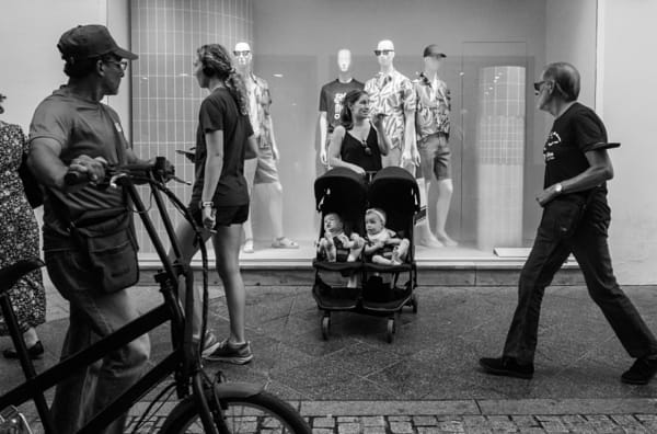 People standing by bicycles in city by Carlos Garea on 500px.com