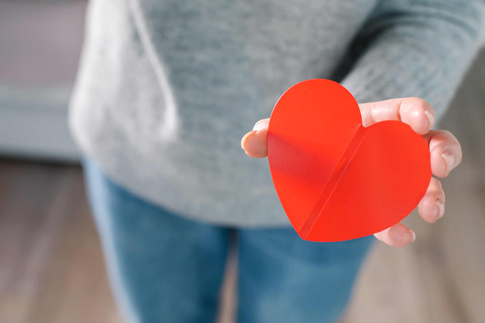 Female hands holding red heart. Concept of health care, donate, wellness