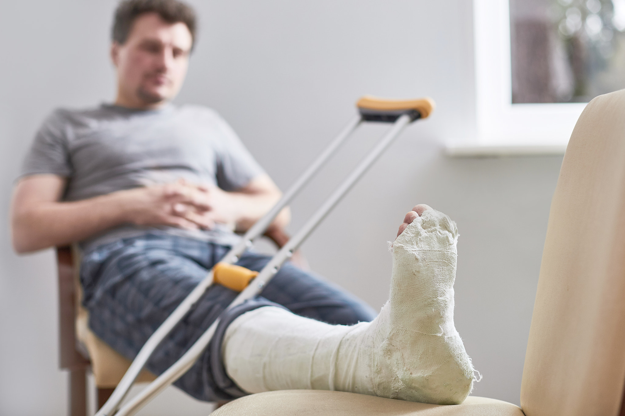 Close up of a young man's Plaster leg cast and after a running injury or fall