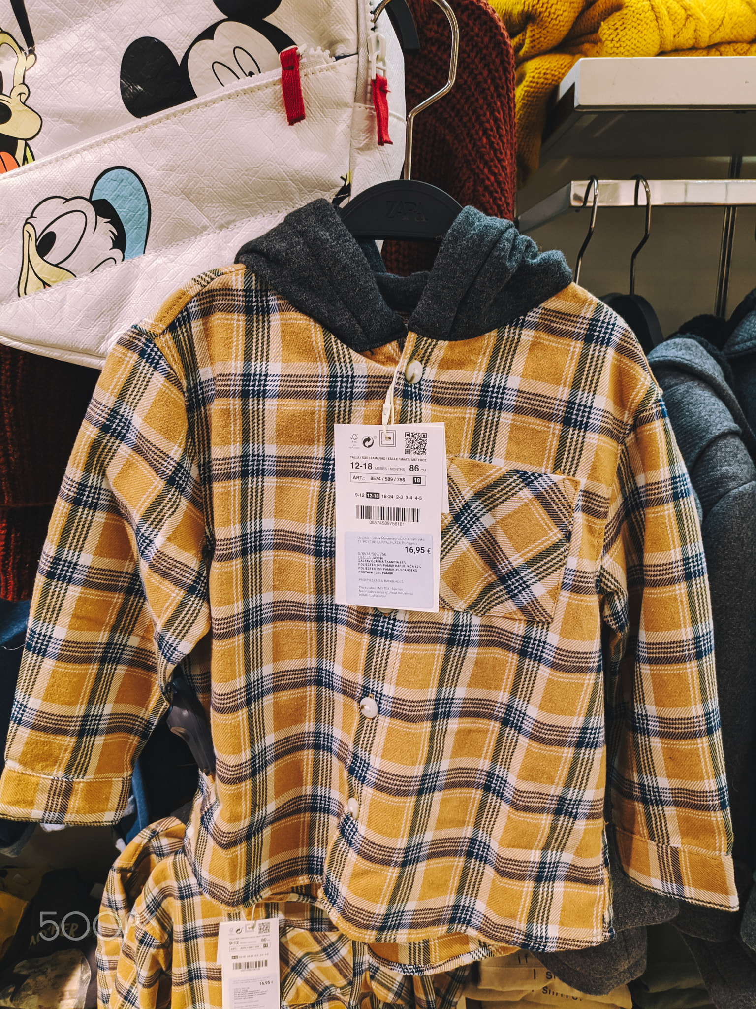 Budva, Montenegro - 01.08.22: Children plaid hooded shirt on a hanger