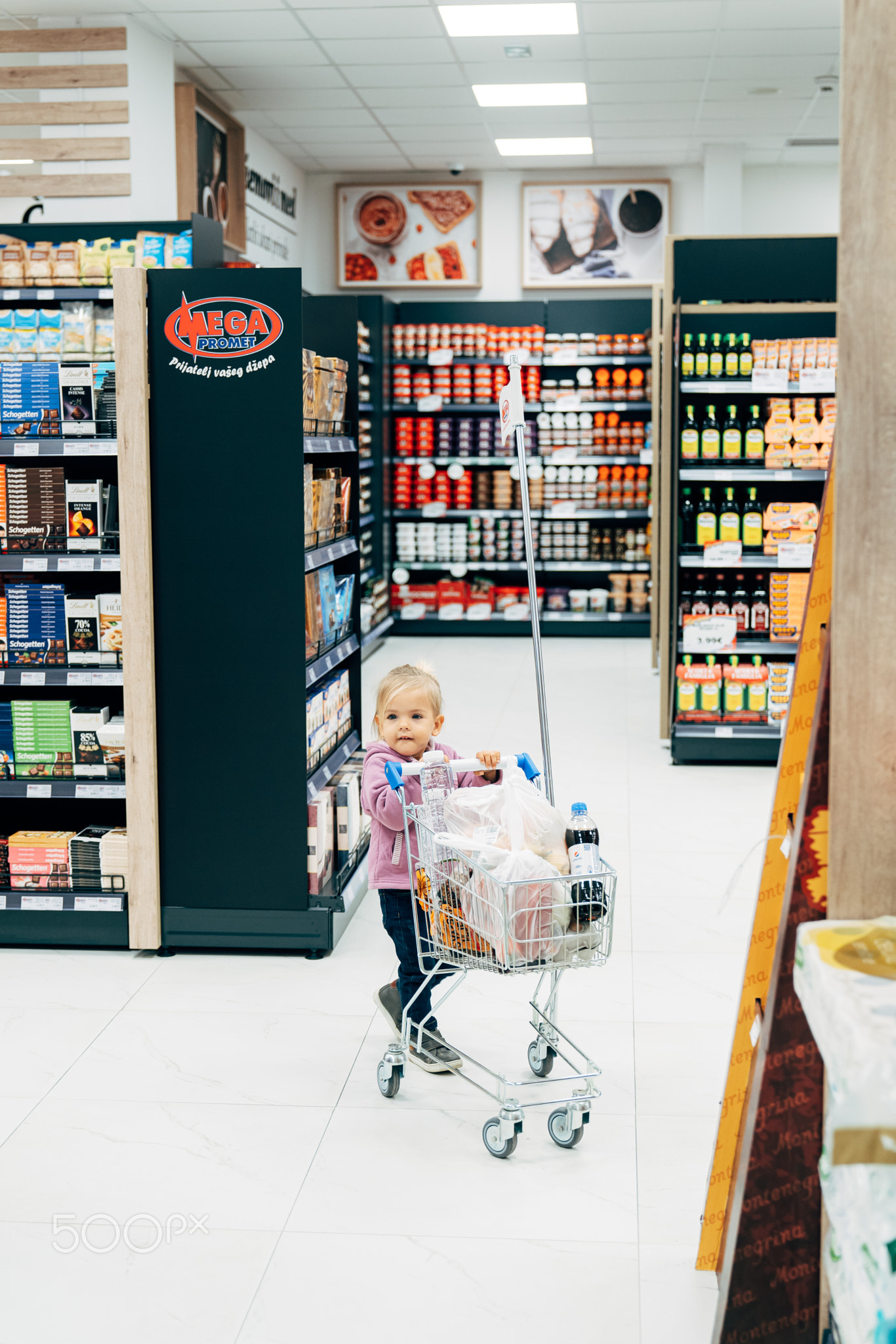 Budva, Montenegro - 17 march 2021: A child with a small cart in a
