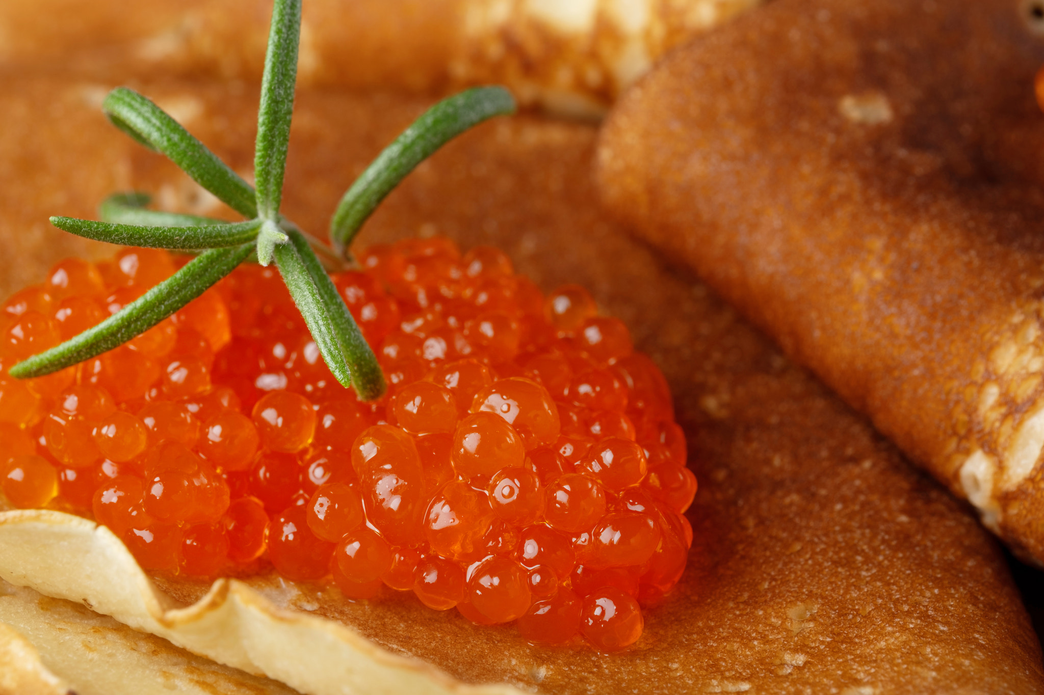 Red caviar with thin pancakes close-up