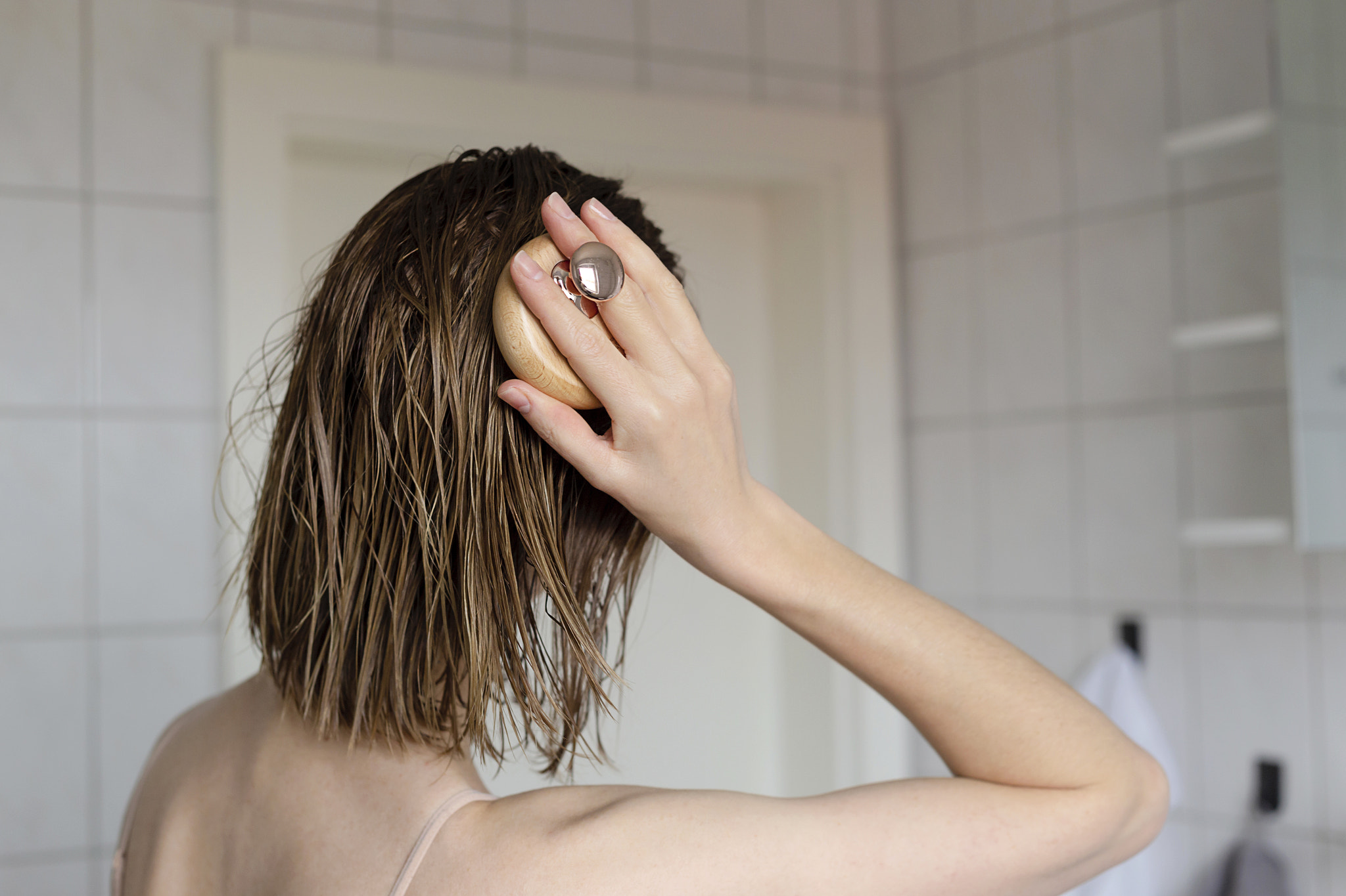 Woman makes a head self massage for hair growth.