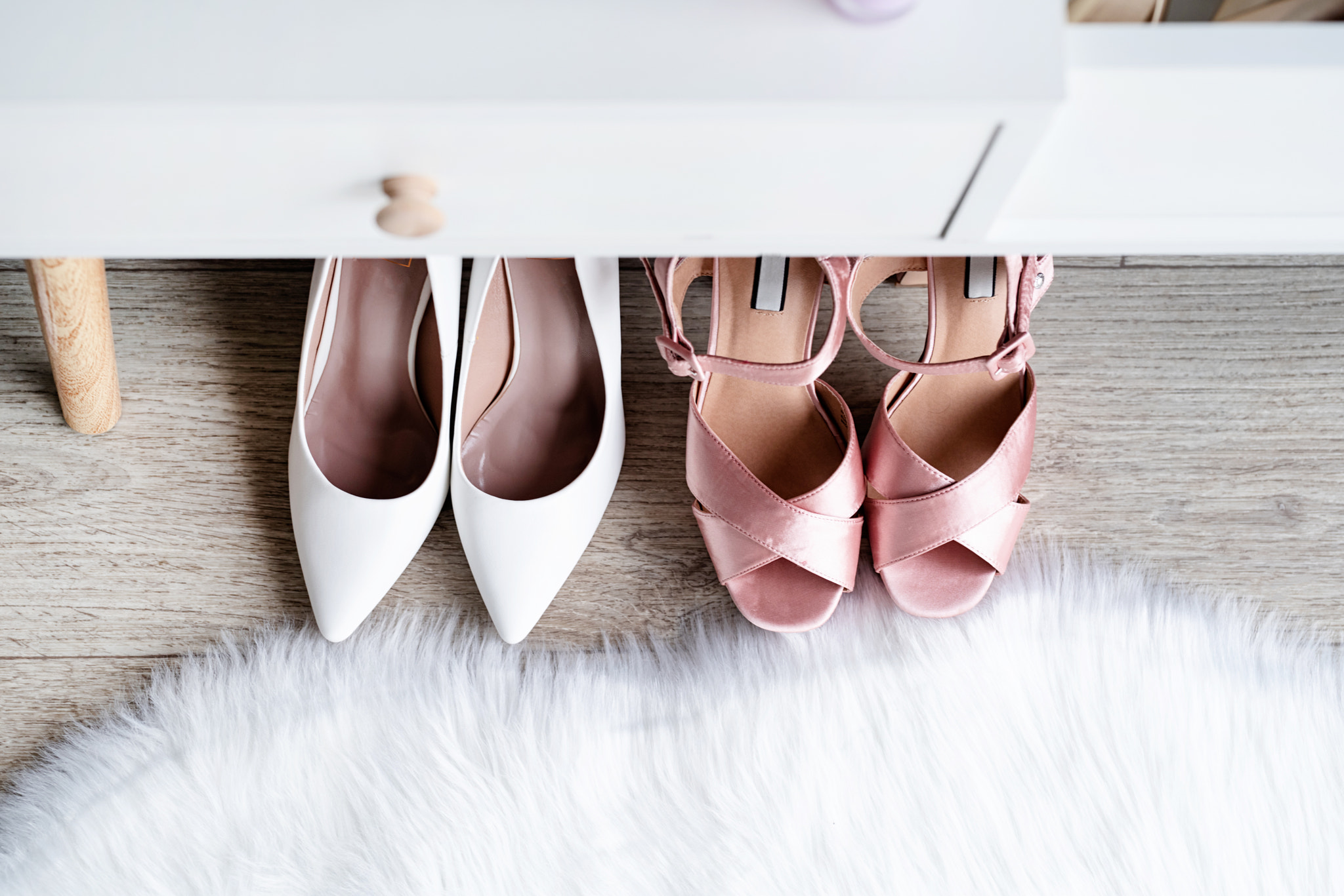 closeup of elegant high heel shoes standing under feminine dressing table