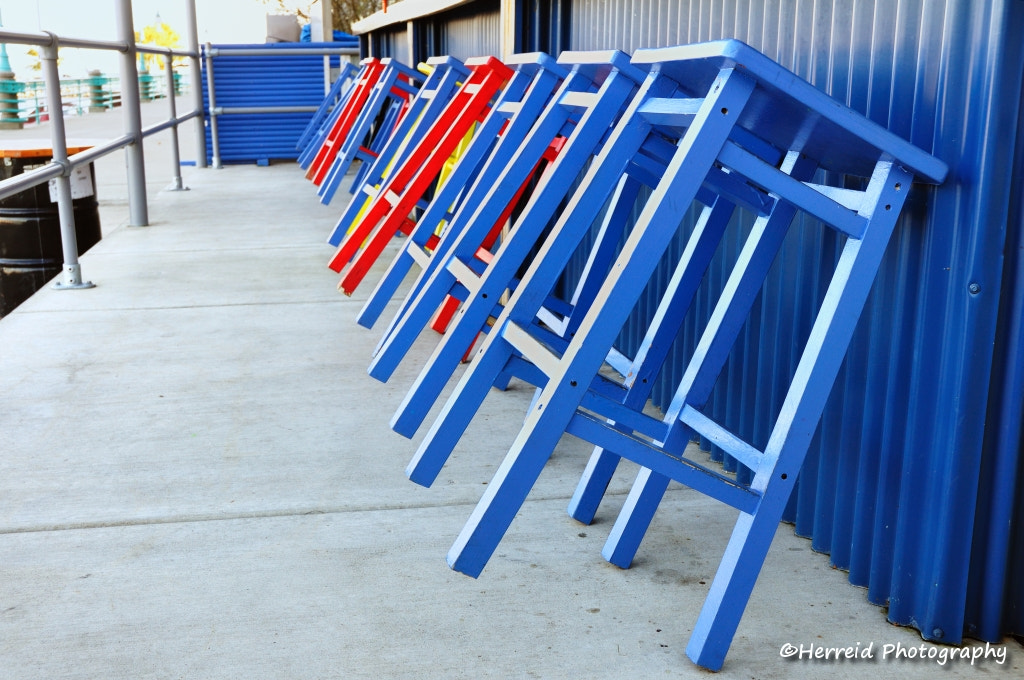 Red and Blue Stools Leaning Against Bar