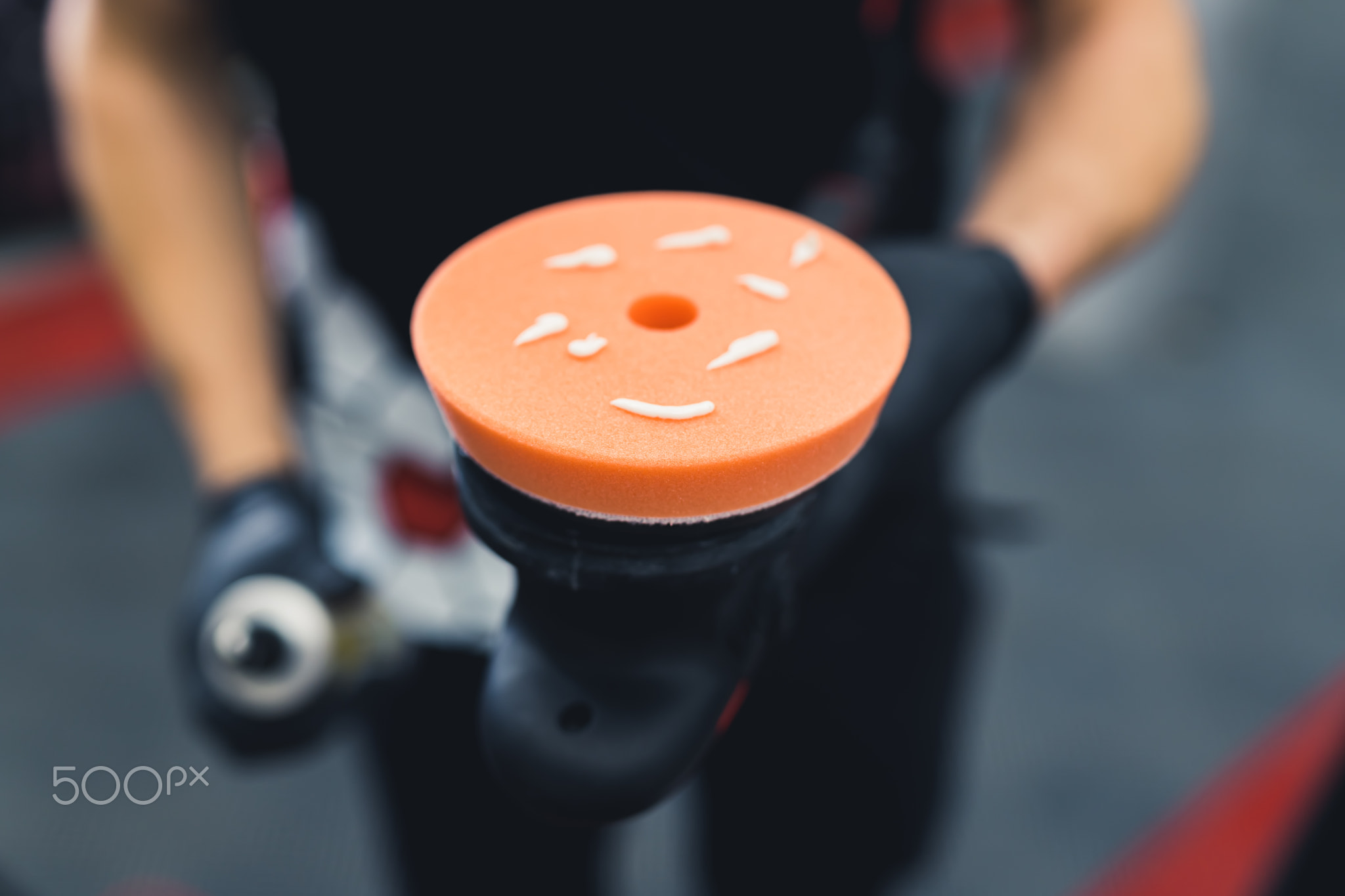 Orbital polisher ready to use. Unrecognizable blurred person holding