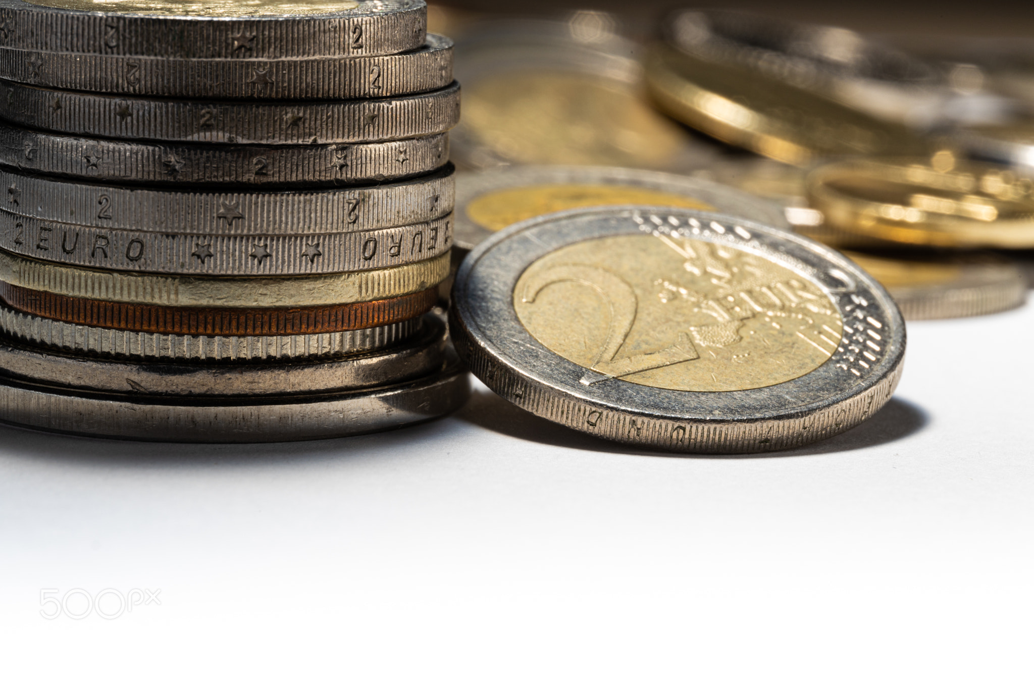 Stack of the coins and Two euro coin with soft focus