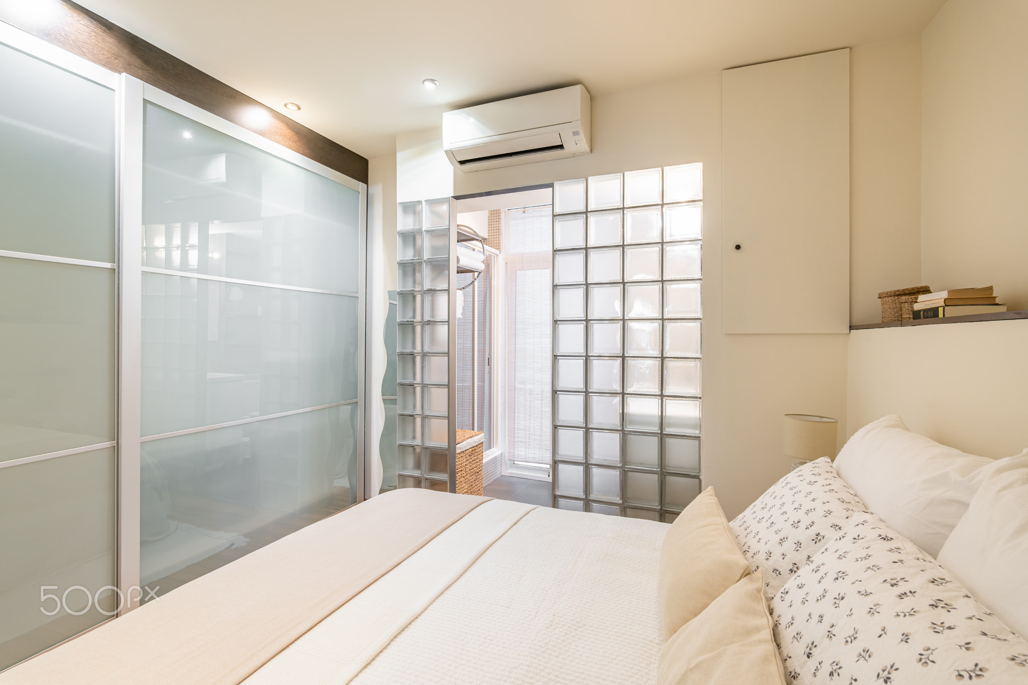 Bedroom in modern design with glass blocks and wardrobe with air