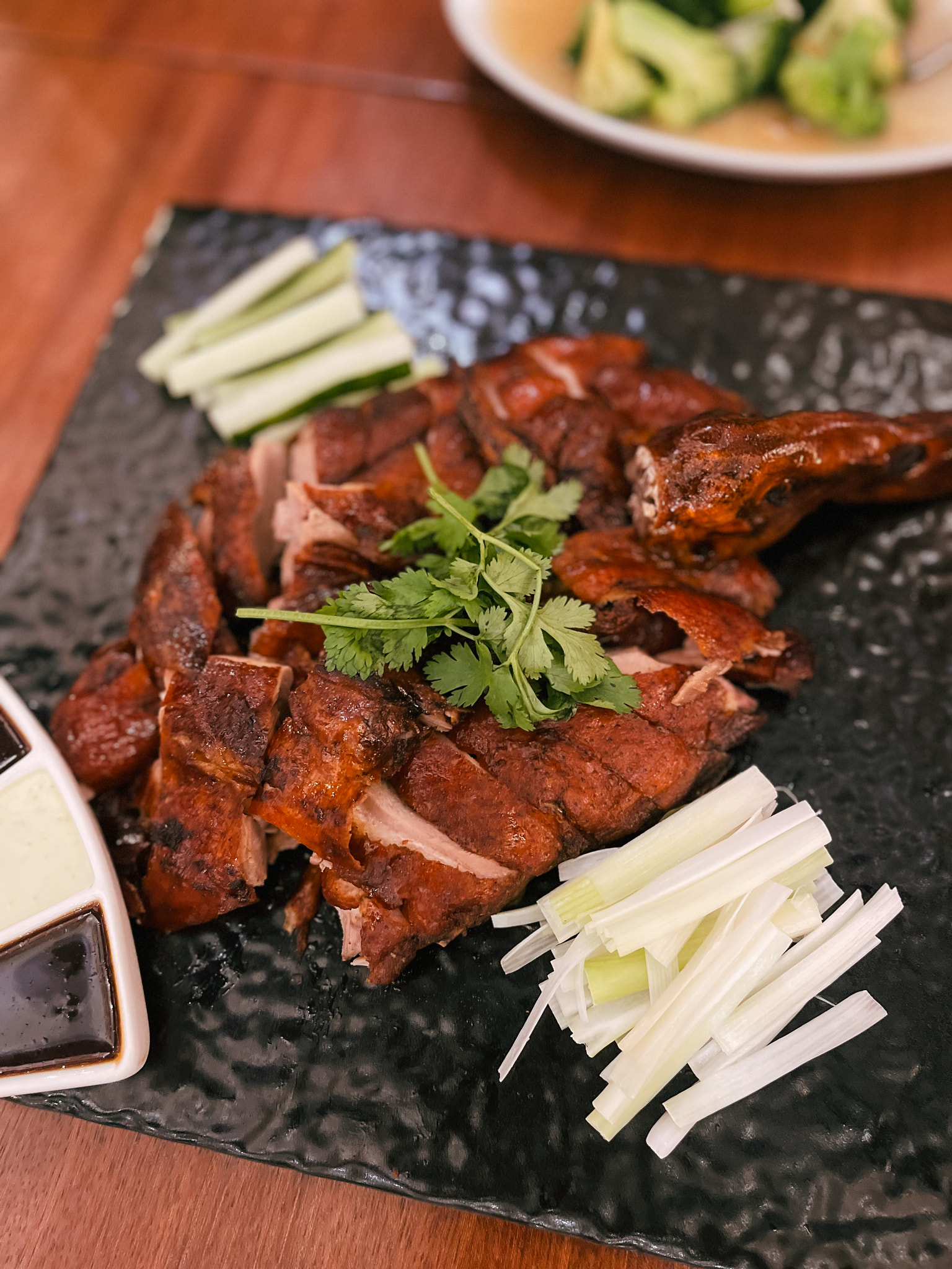 Roast duck served on a black square plate