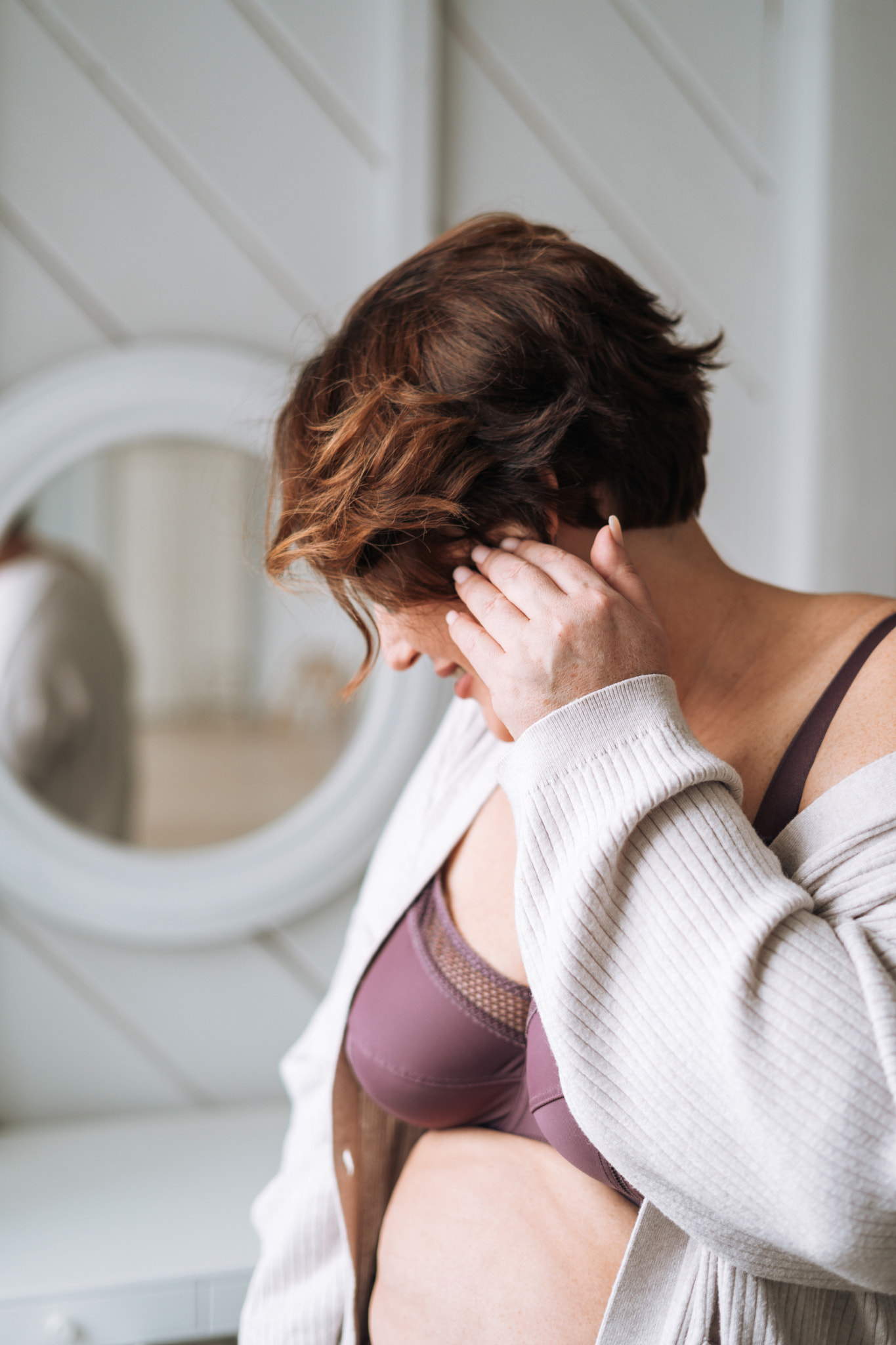 Self loving middle aged brunette woman in underwear in bedroom at home