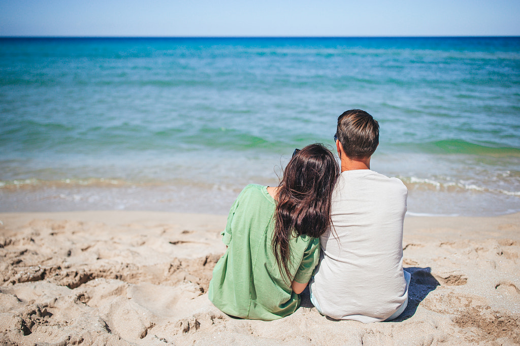 Young couple on white beach during summer vacation by Dmitrii Travnikov ...