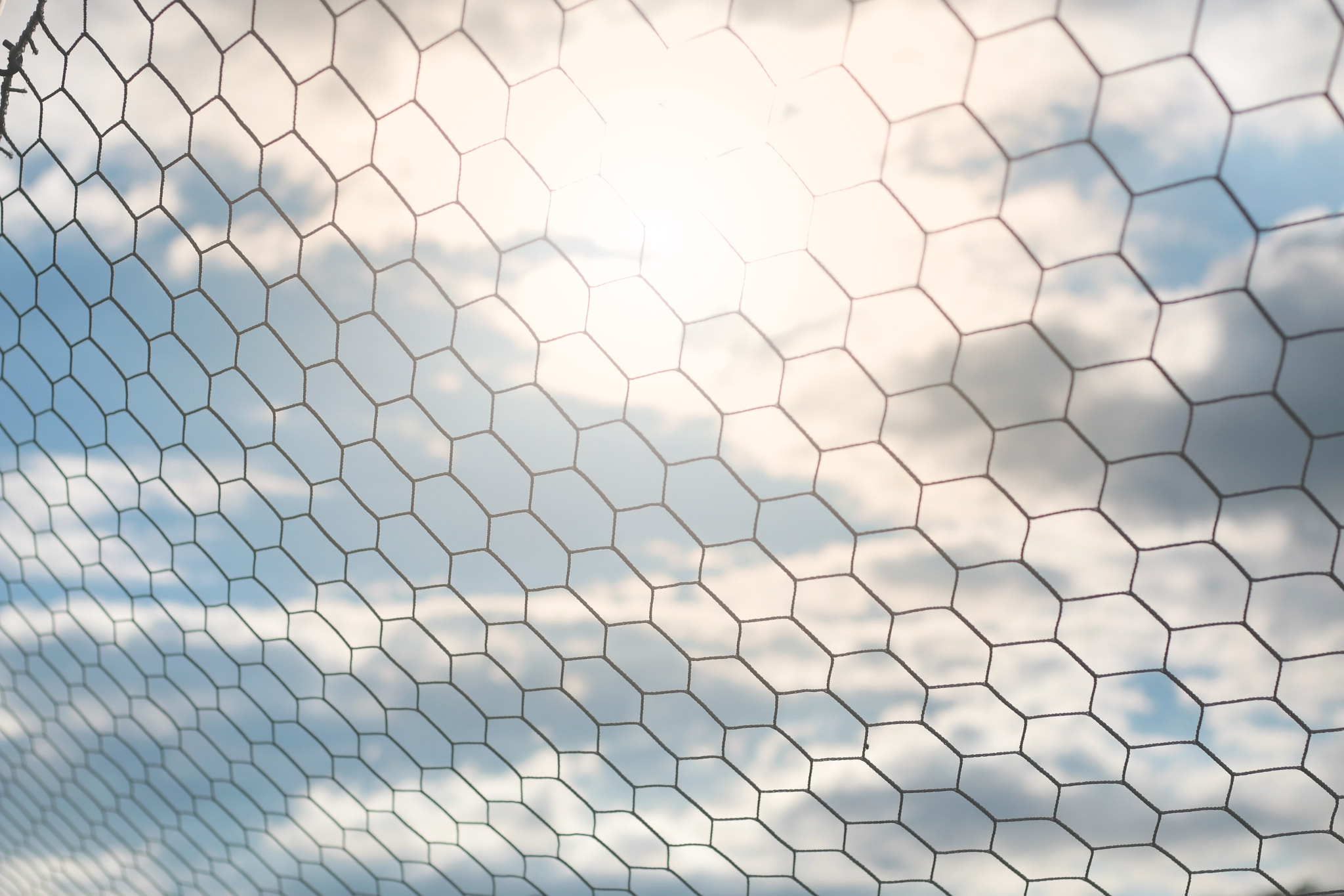 Detail of football net with sunlight in the field background, Football equipment