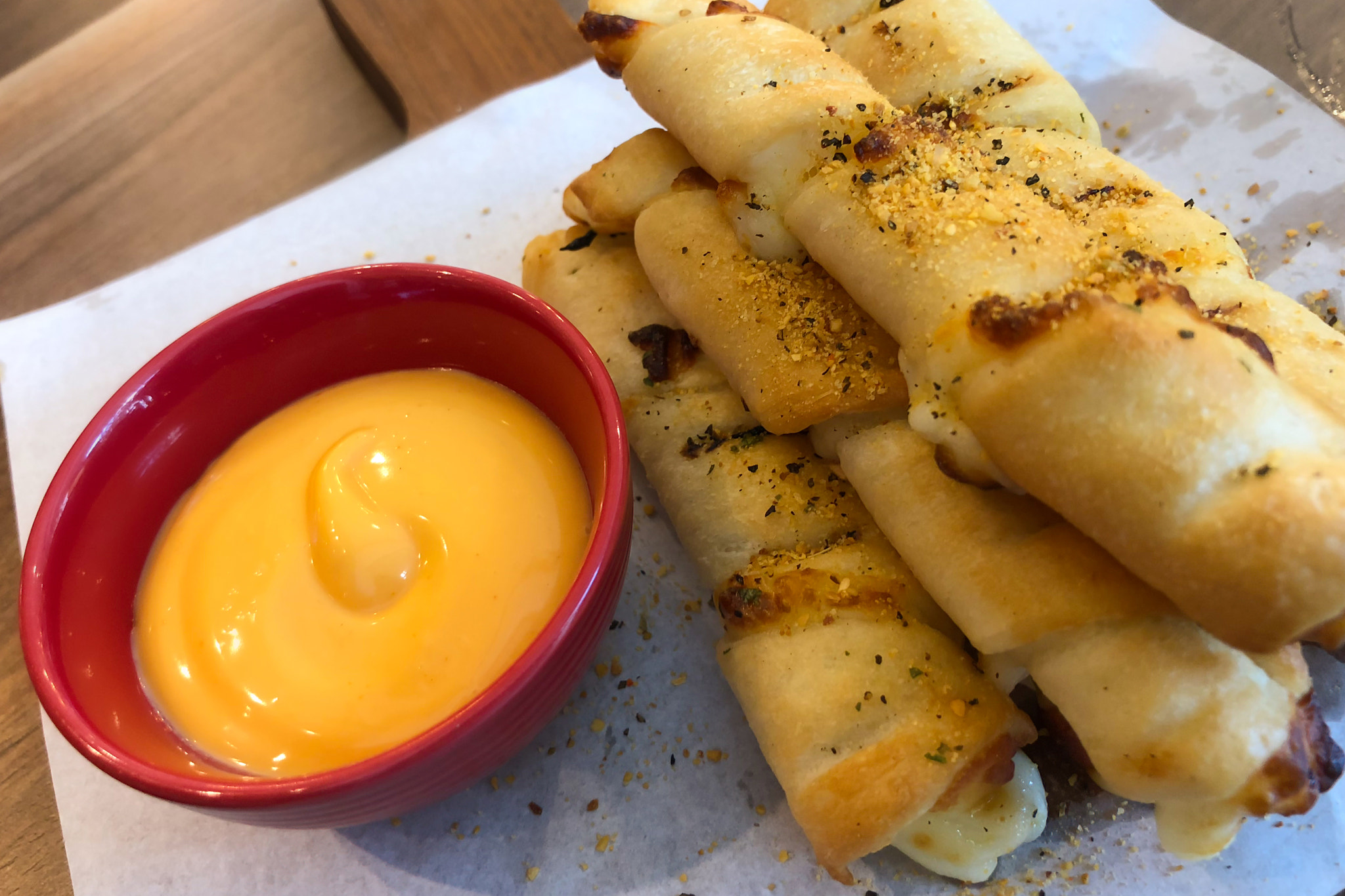 Bread stick with dip cheeses on a board in restaurant