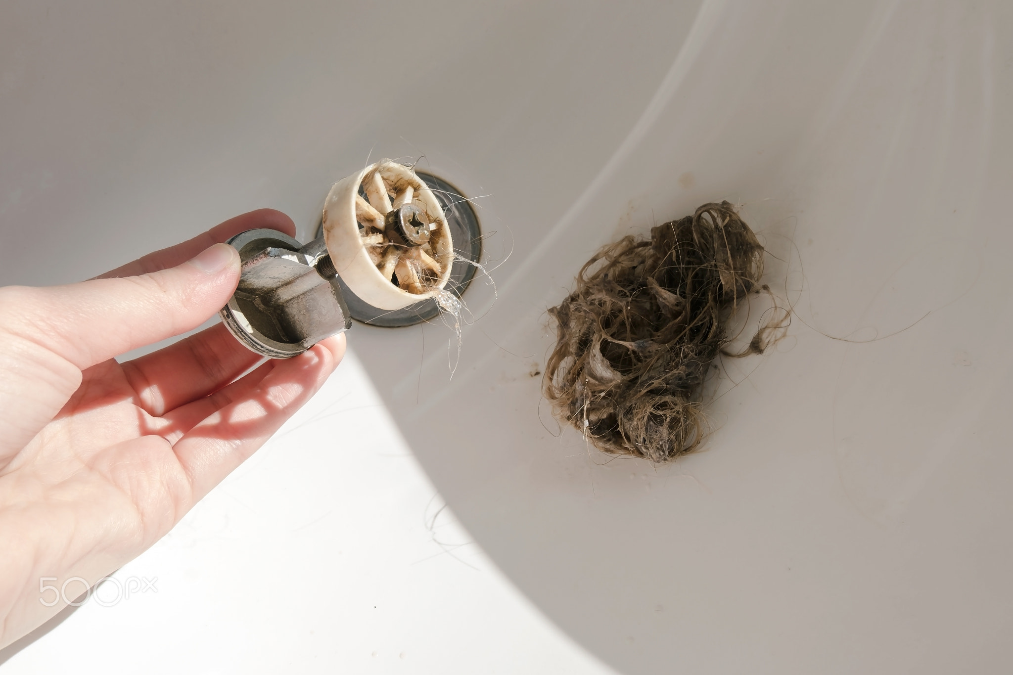 Big hair and garbage in bath drain cover. Clogged strainer with hairs