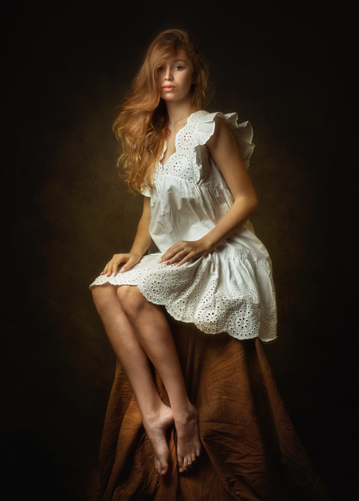 Portrait of young woman sitting on black background by Zachar Rise on 500px.com