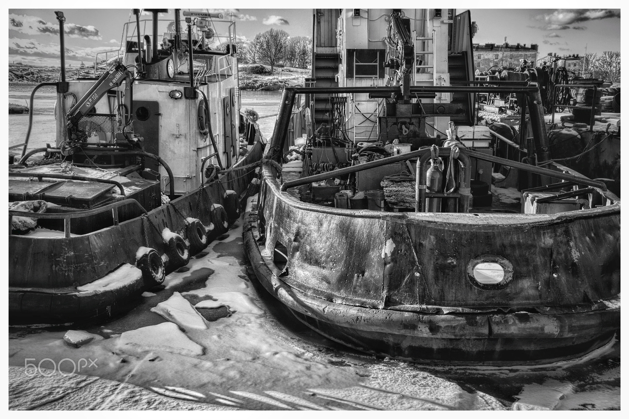 Tugboats moored in winter