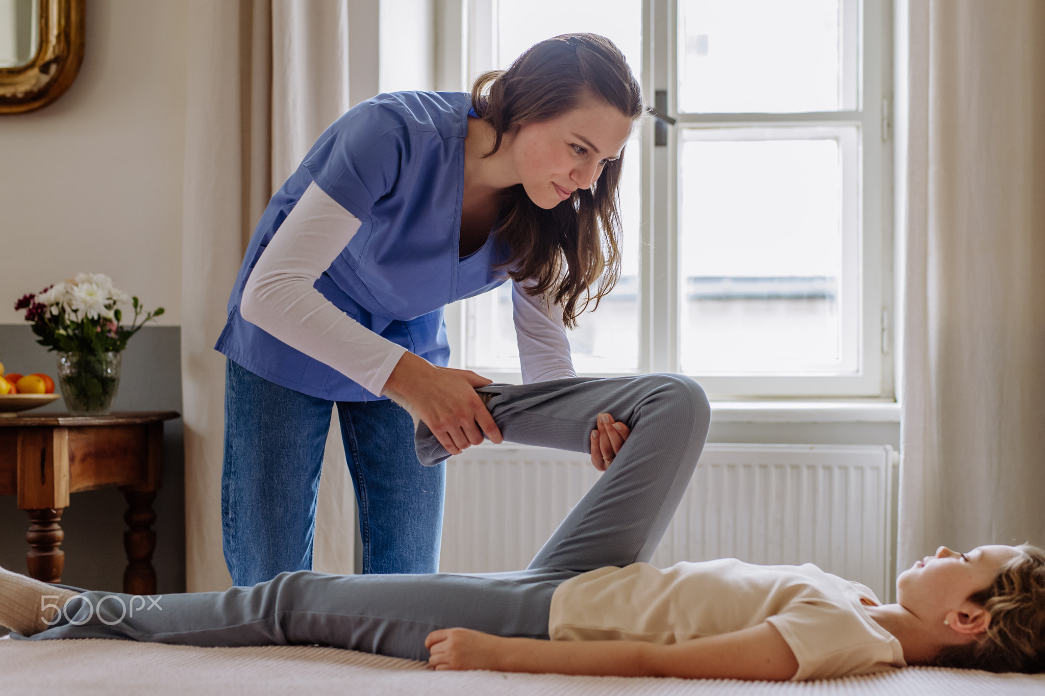 Little girl doing exercise with a nurse.