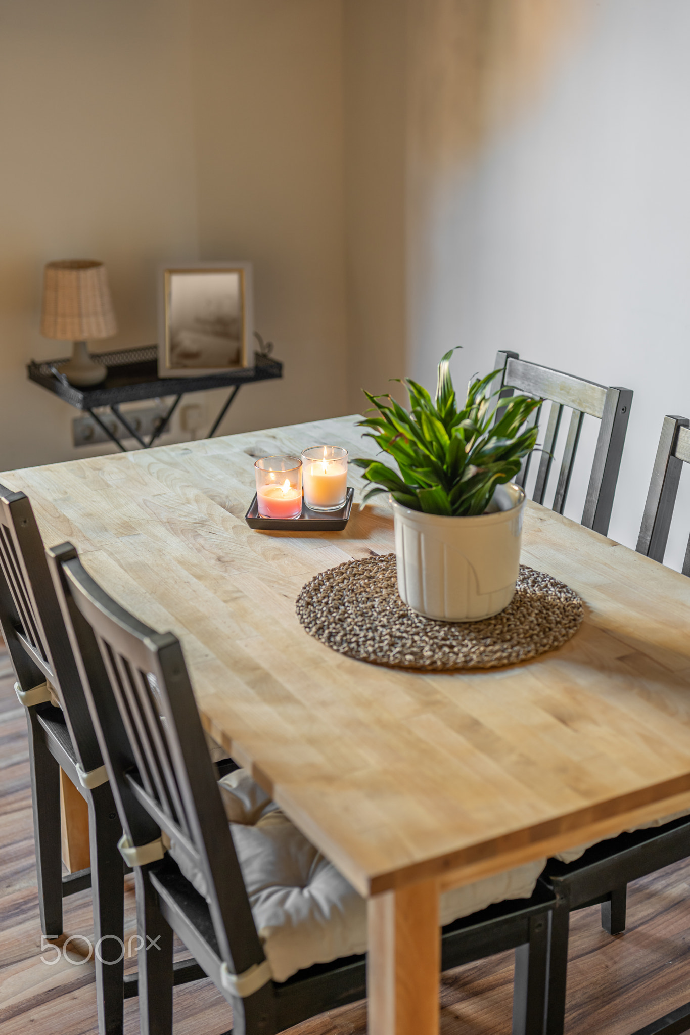 Top view of wooden dining table with chairs and decorative elements