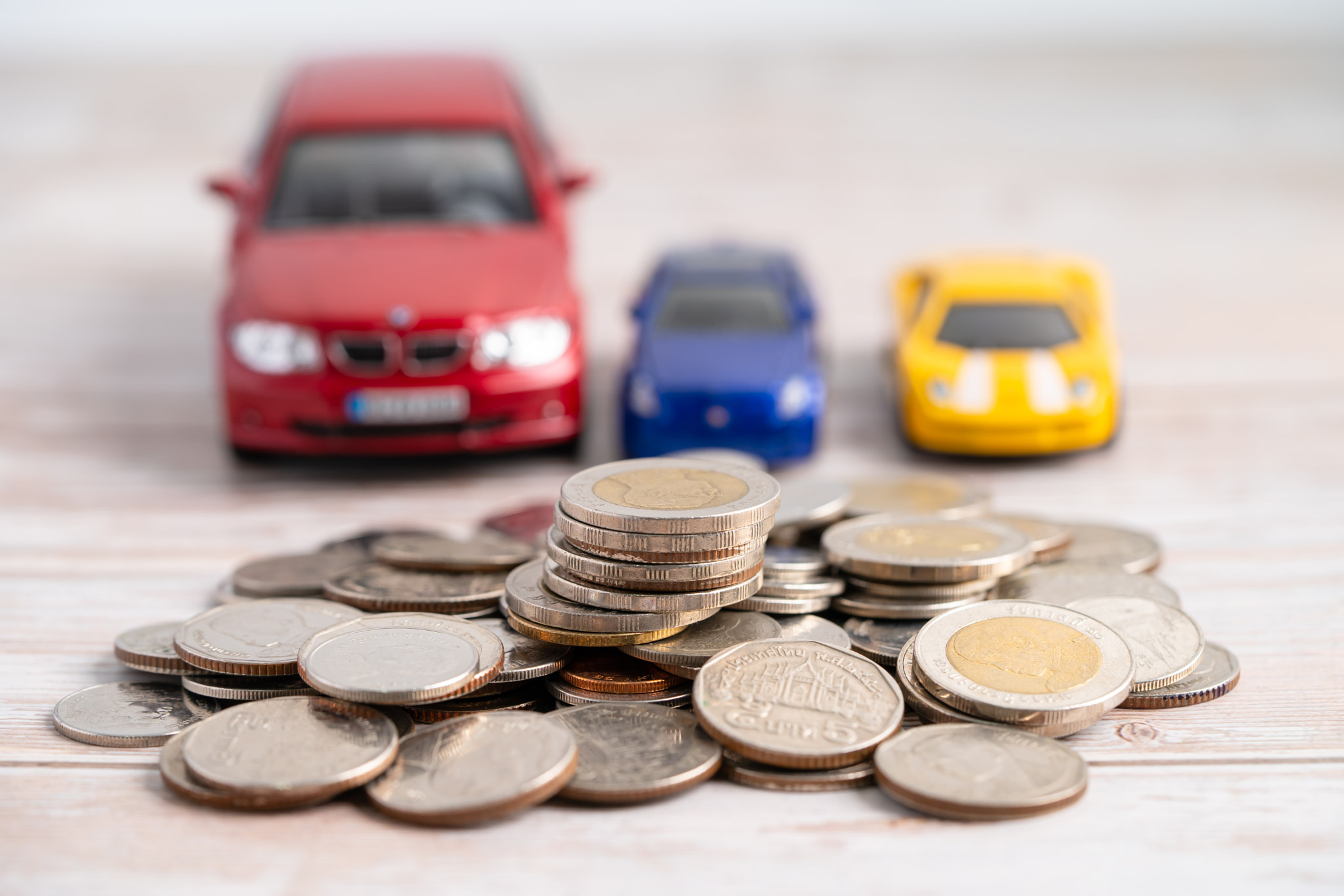 Car on coins background; Car loan, Finance, saving money, insurance and leasing time concepts.