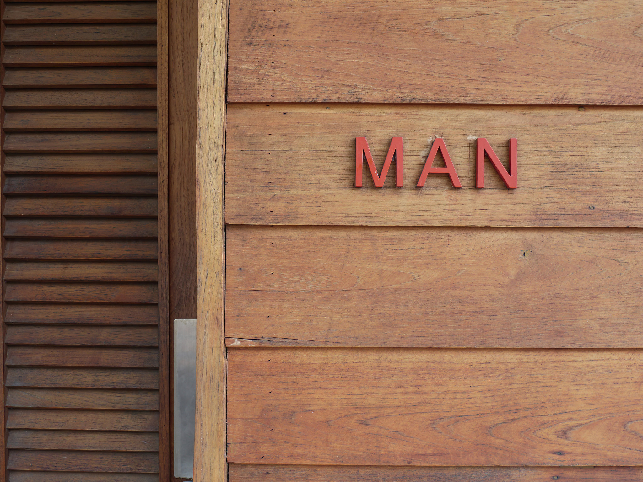 Red letter of MAN on the wooden wall