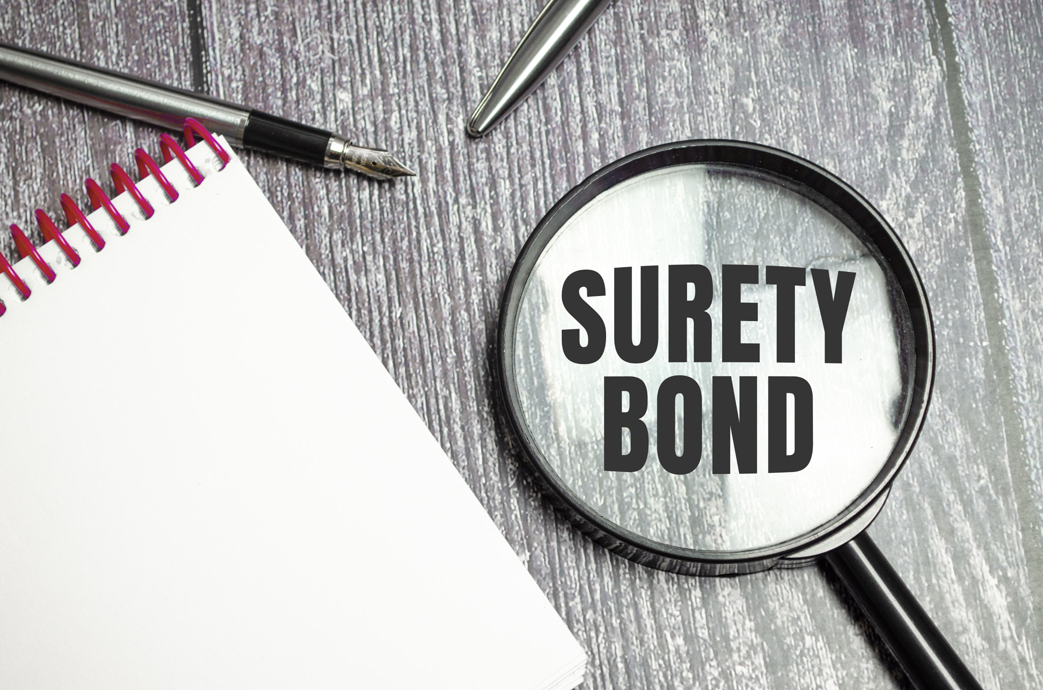 a magnifying glass with the inscription - Surety Bond
