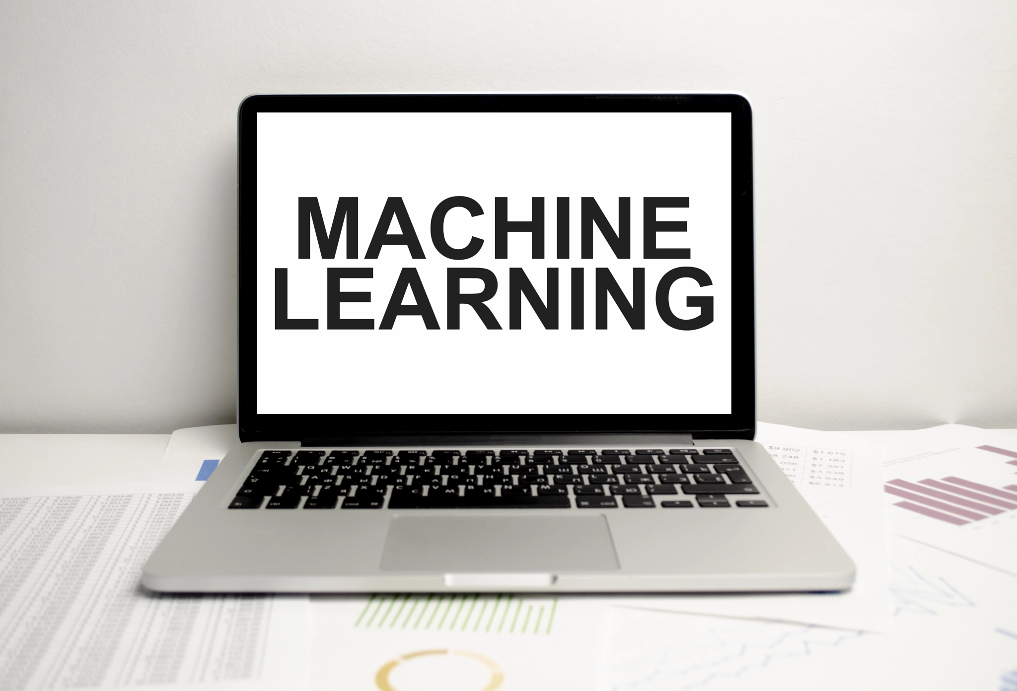Machine learning words on laptop display and charts