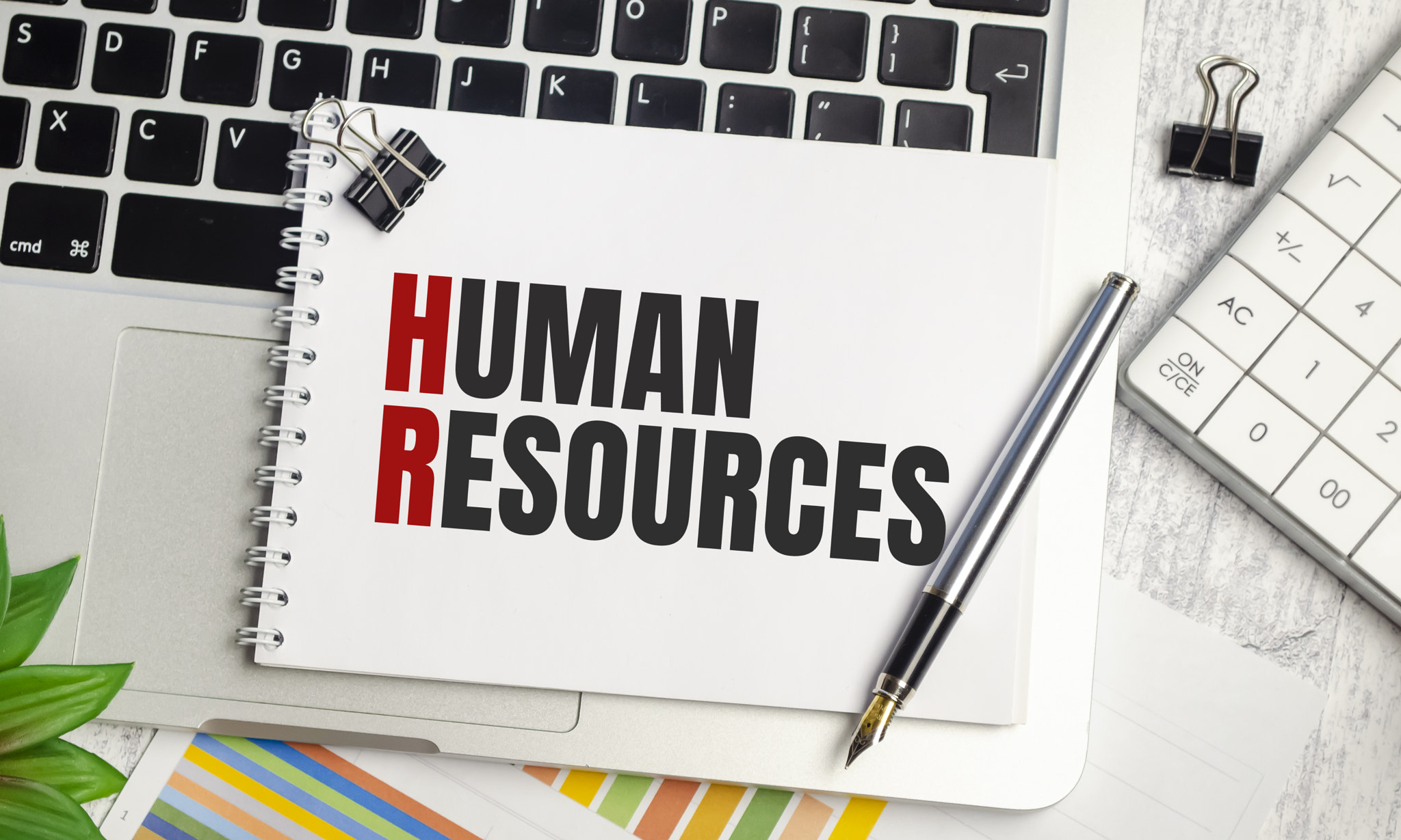 human resources . text on white paper and laptop on wooden background