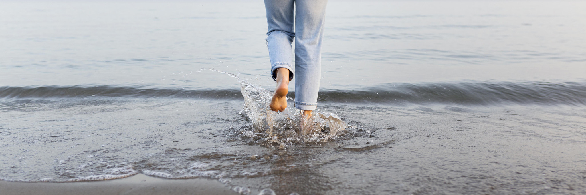 woman getting into sea