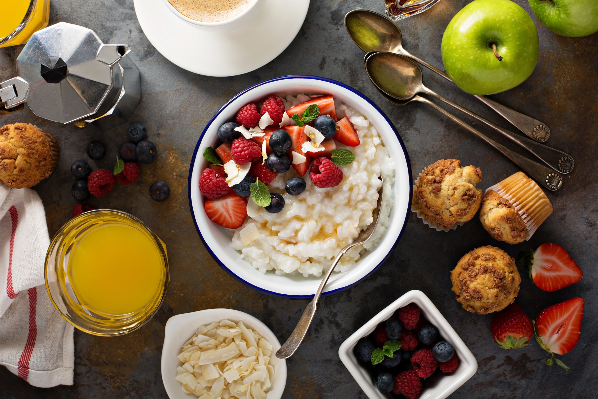 Breakfast table with rice pudding, fruit and muffins