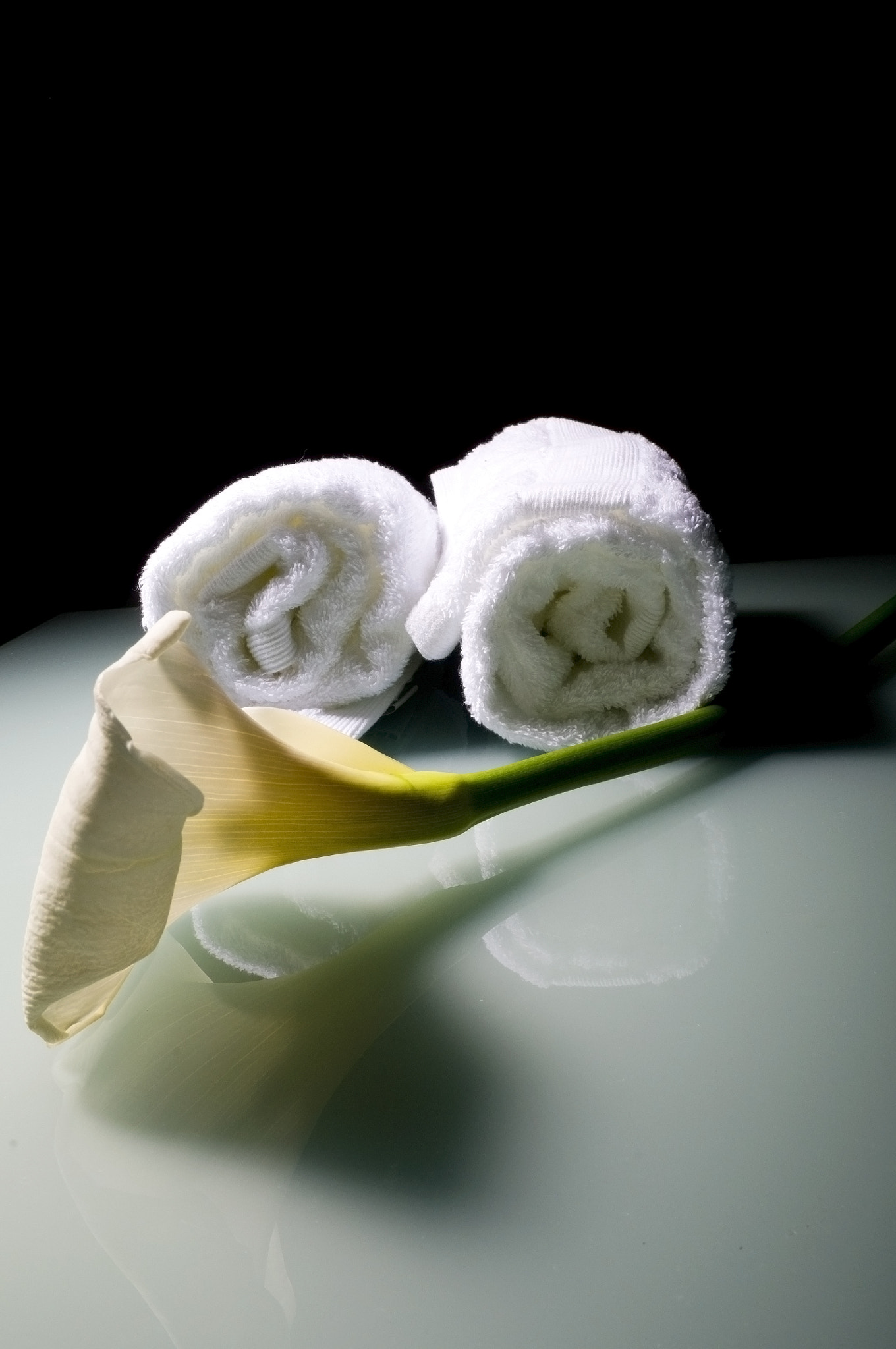 White lily flower with towels on glass