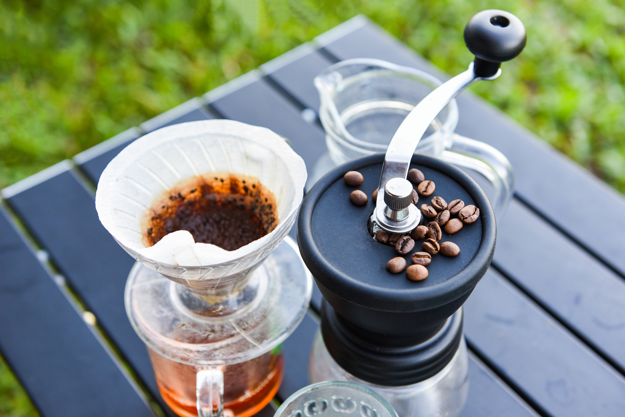 drip coffee barista pouring water on filtered brewing, make cup hand drip coffee in glass jar on out