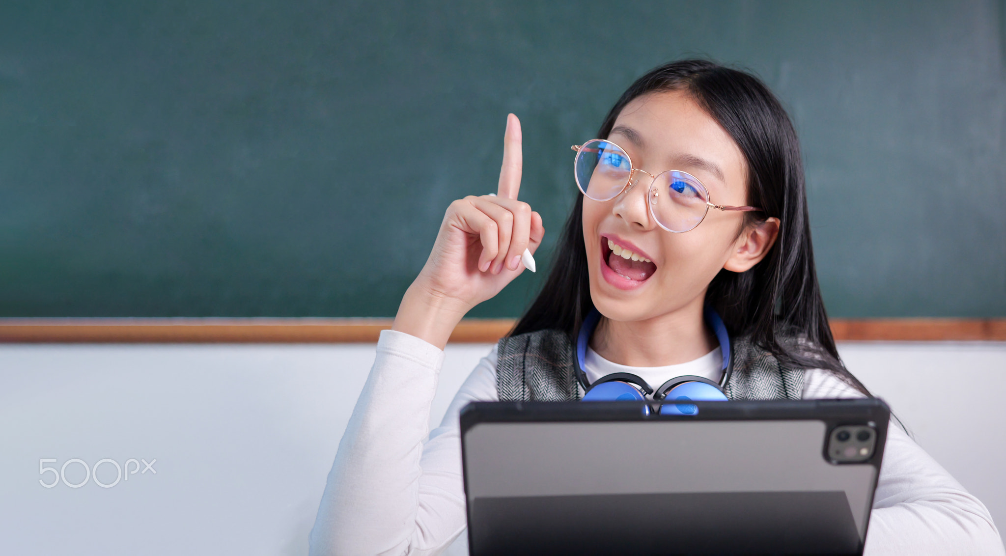 Student studying and reading textbook with happiness in classroom