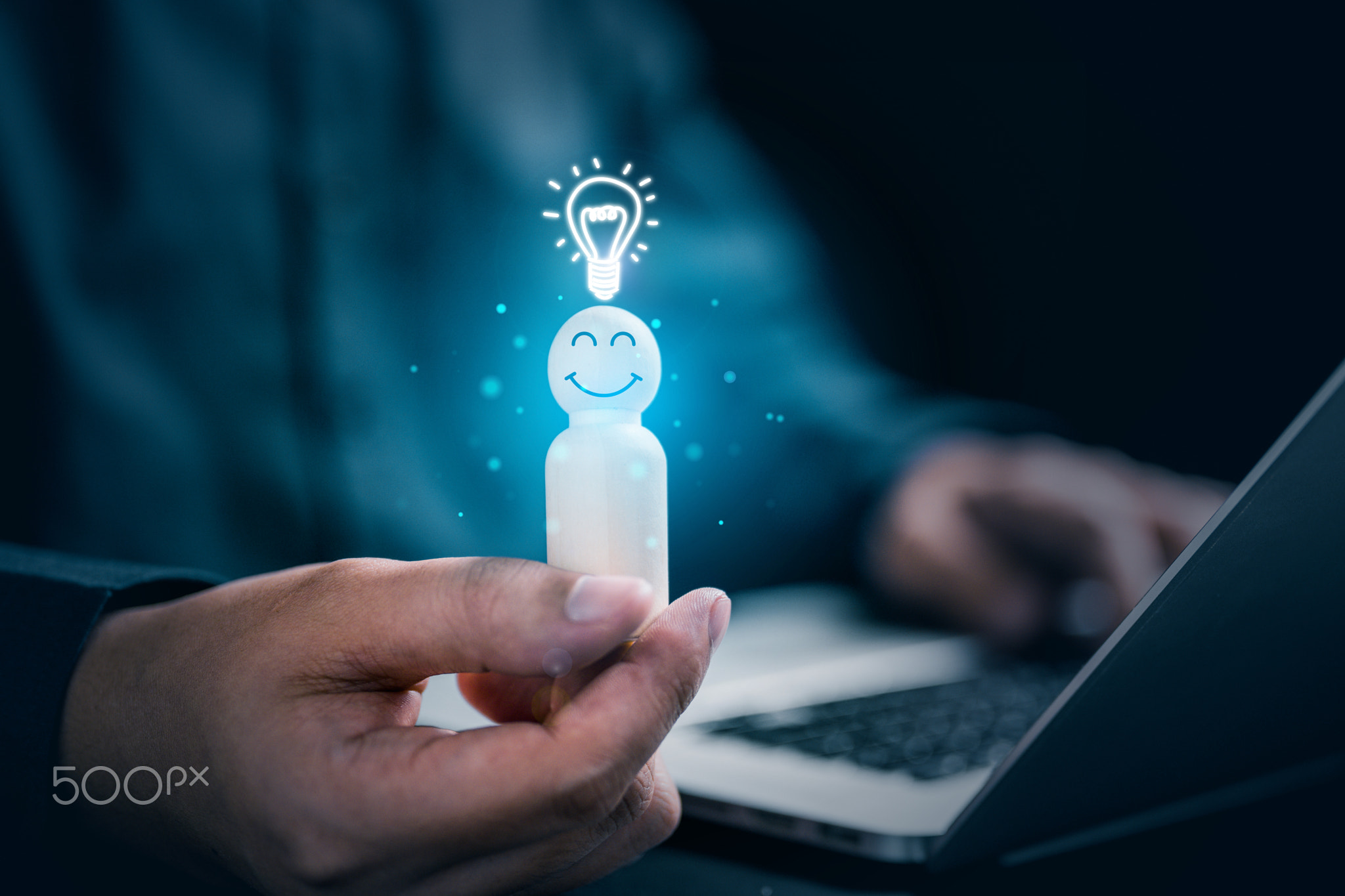 Hands holding wooden doll employee and light bulb icon