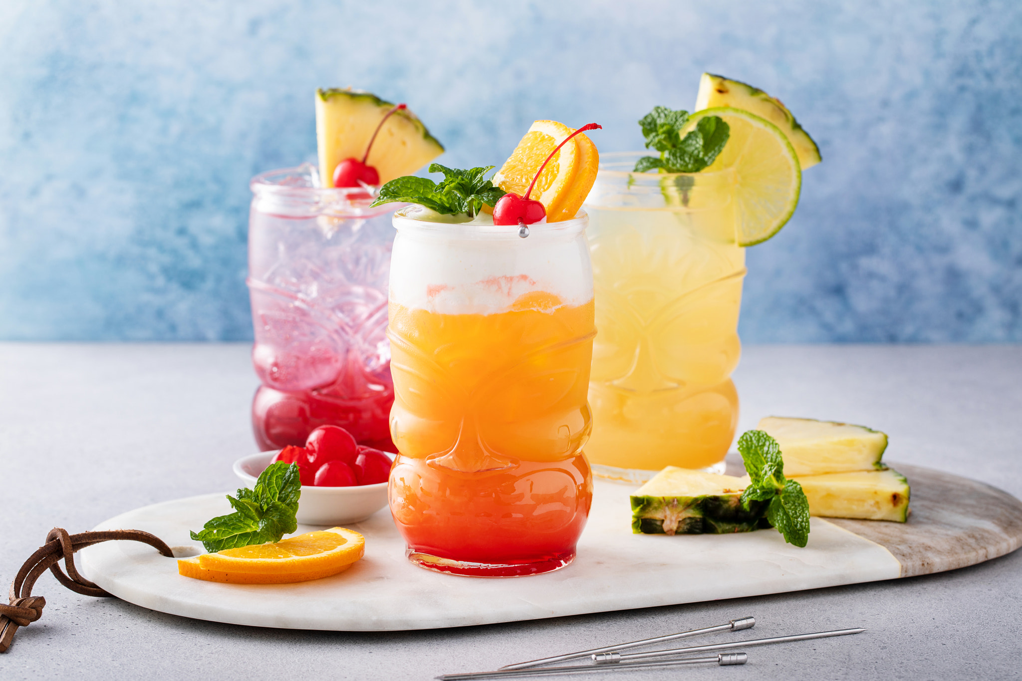 Variety of tiki cocktails in glass cups