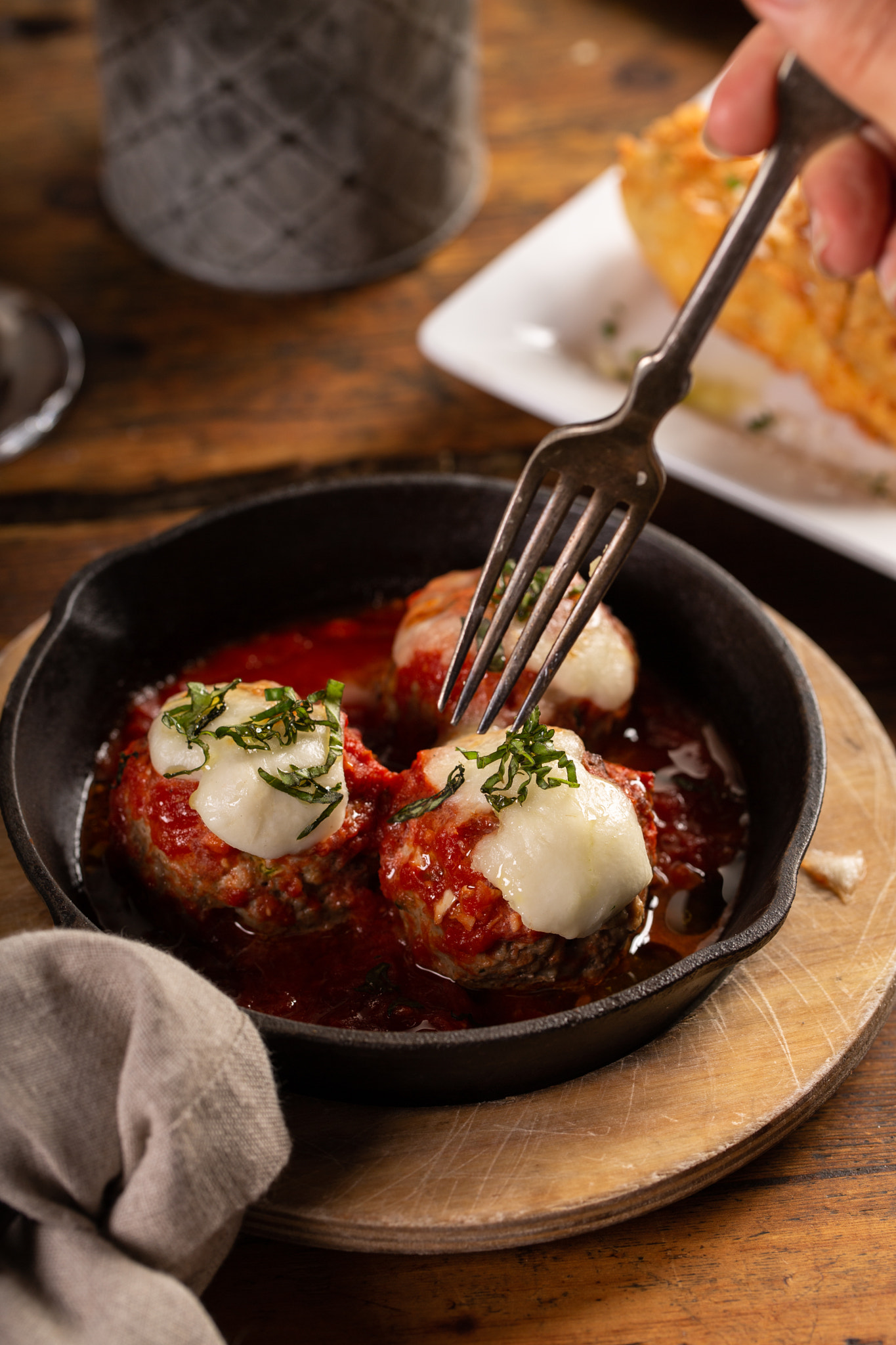 Baked meatballs in marinara sauce with cheese and basil