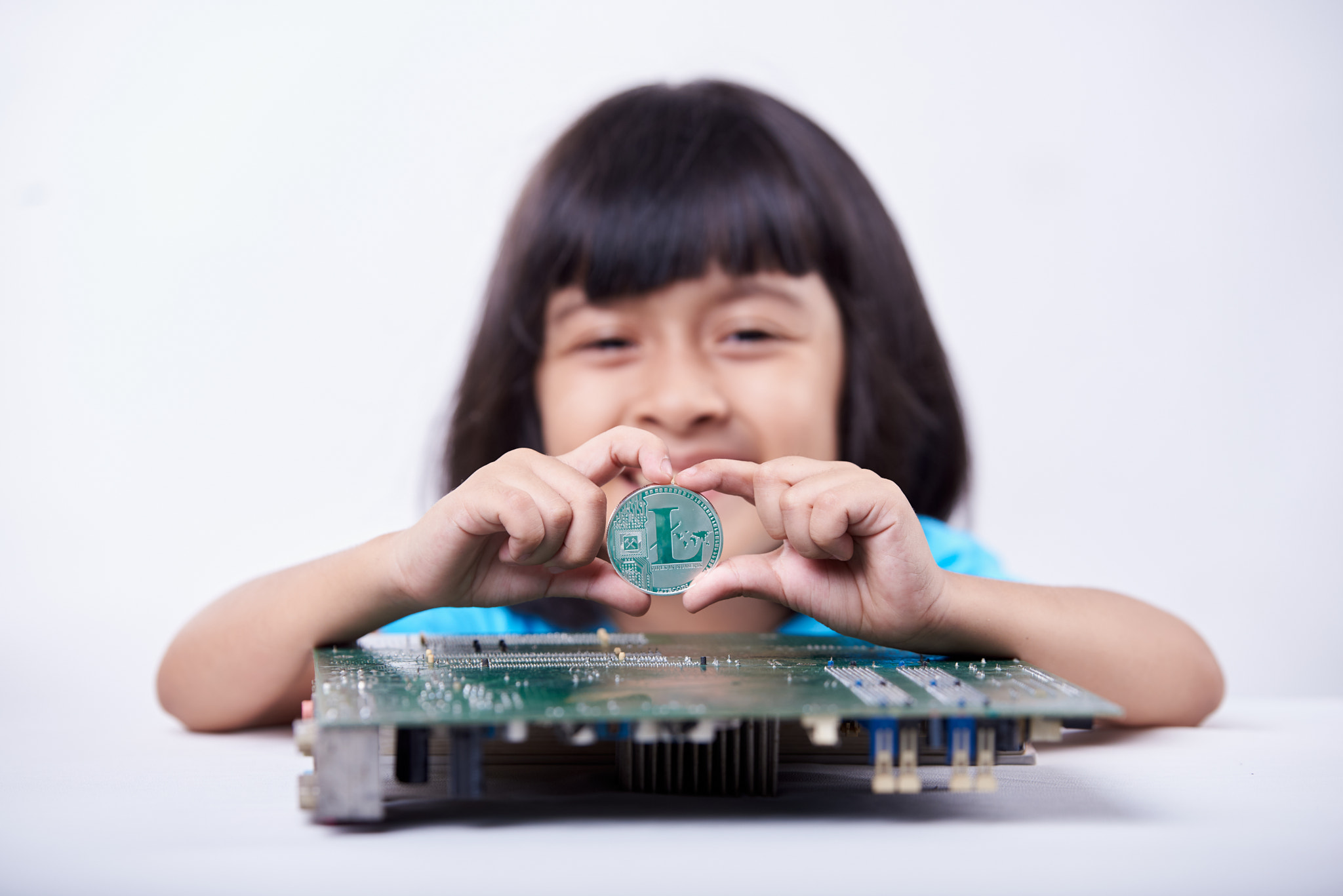 Cute little girl holding Crypto Coin in her hand