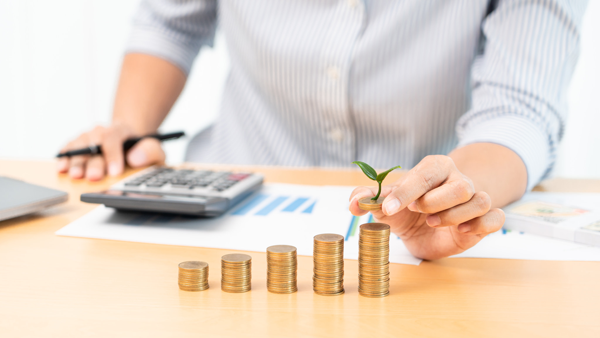 Saving money and investment concept, Business accountant woman stacking coins into increasing column