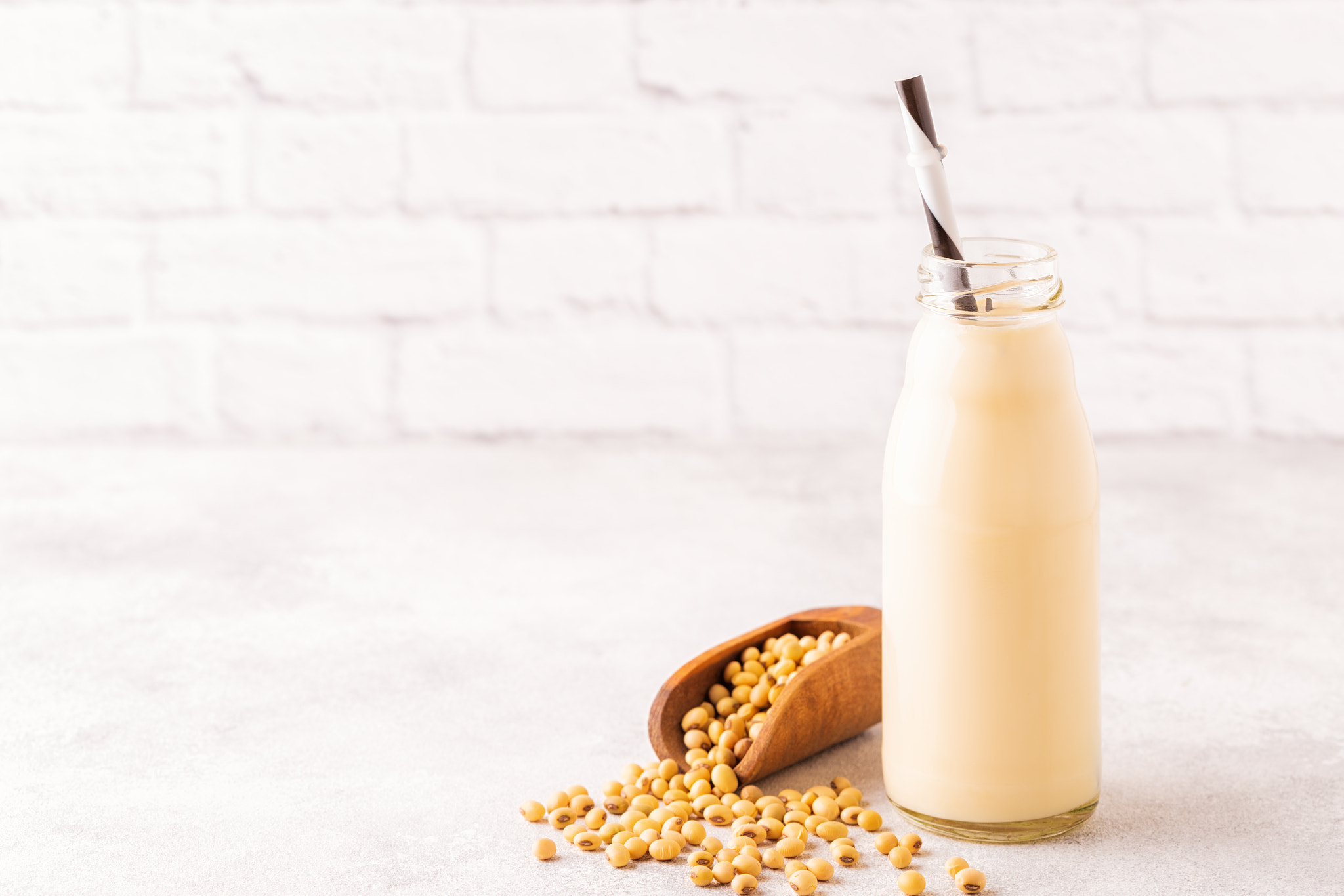 A bottle of soy milk and soy beans