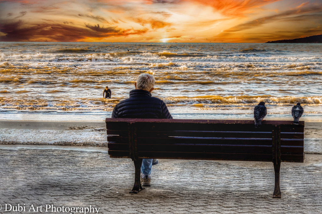 Man watching the sunset at the beach by Dubi Czyzyk on 500px.com