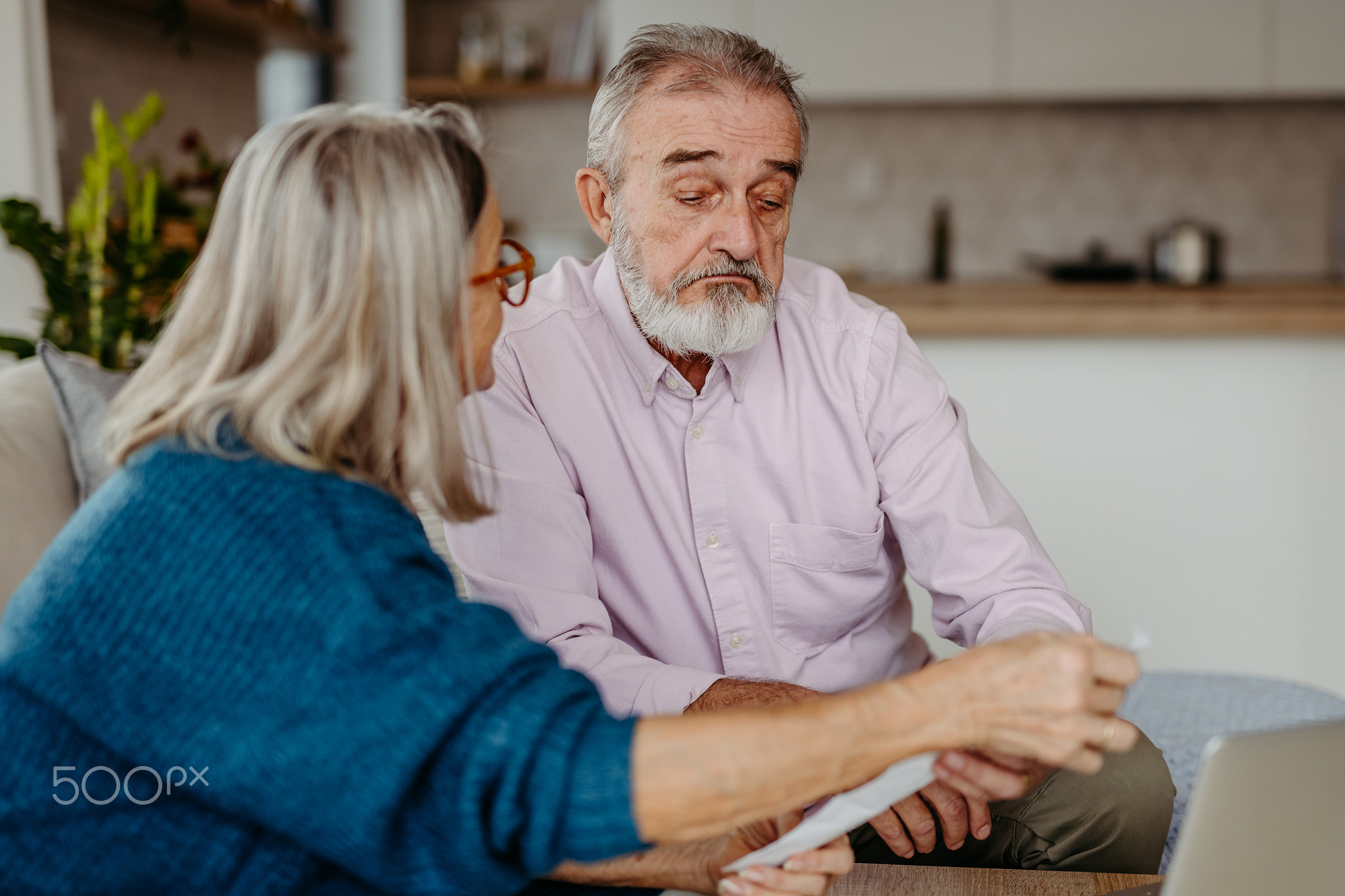 Senior couple checking their bills, concept of family finance.