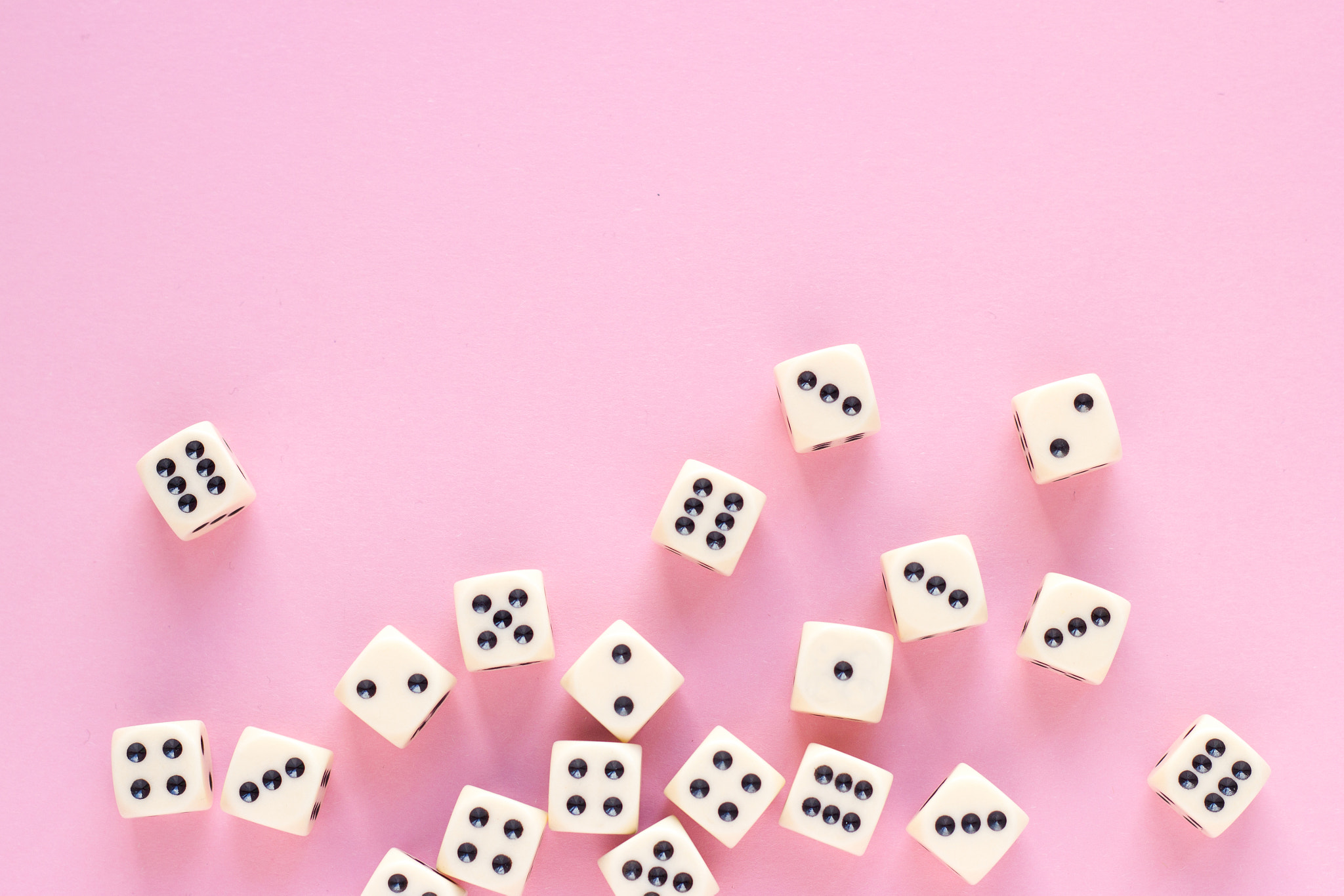 Close-up of dices against pink background