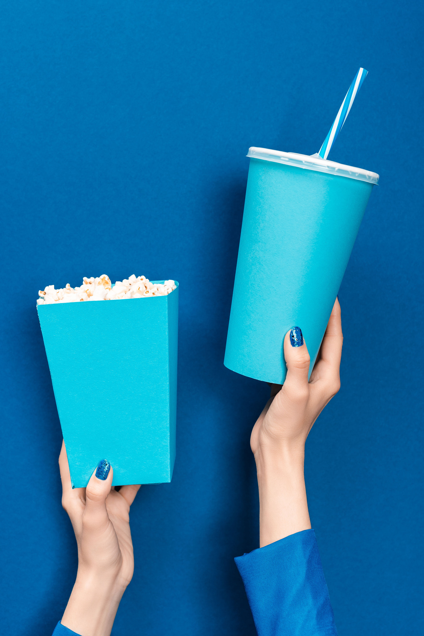 cropped view woman holding popcorn