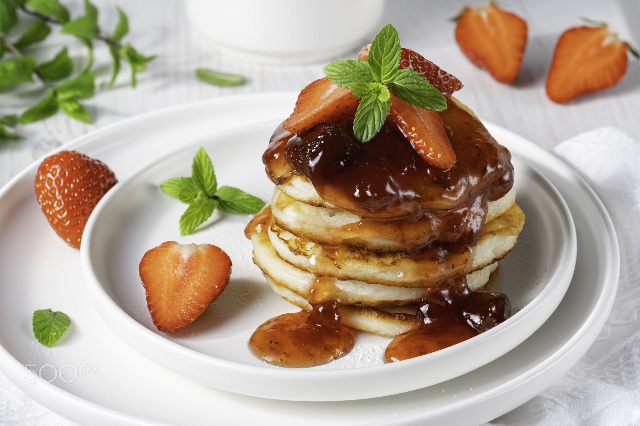 Mini pancakes with strawberry jam and strawberries