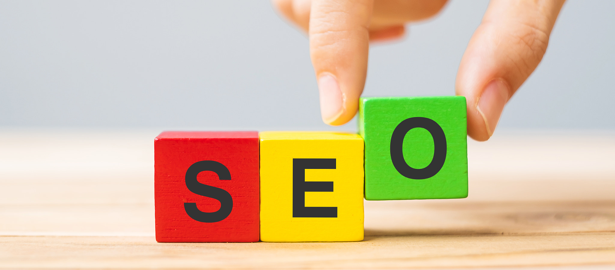 SEO (Search Engine Optimization) text wooden cube blocks on table background. Idea, Strategy, market