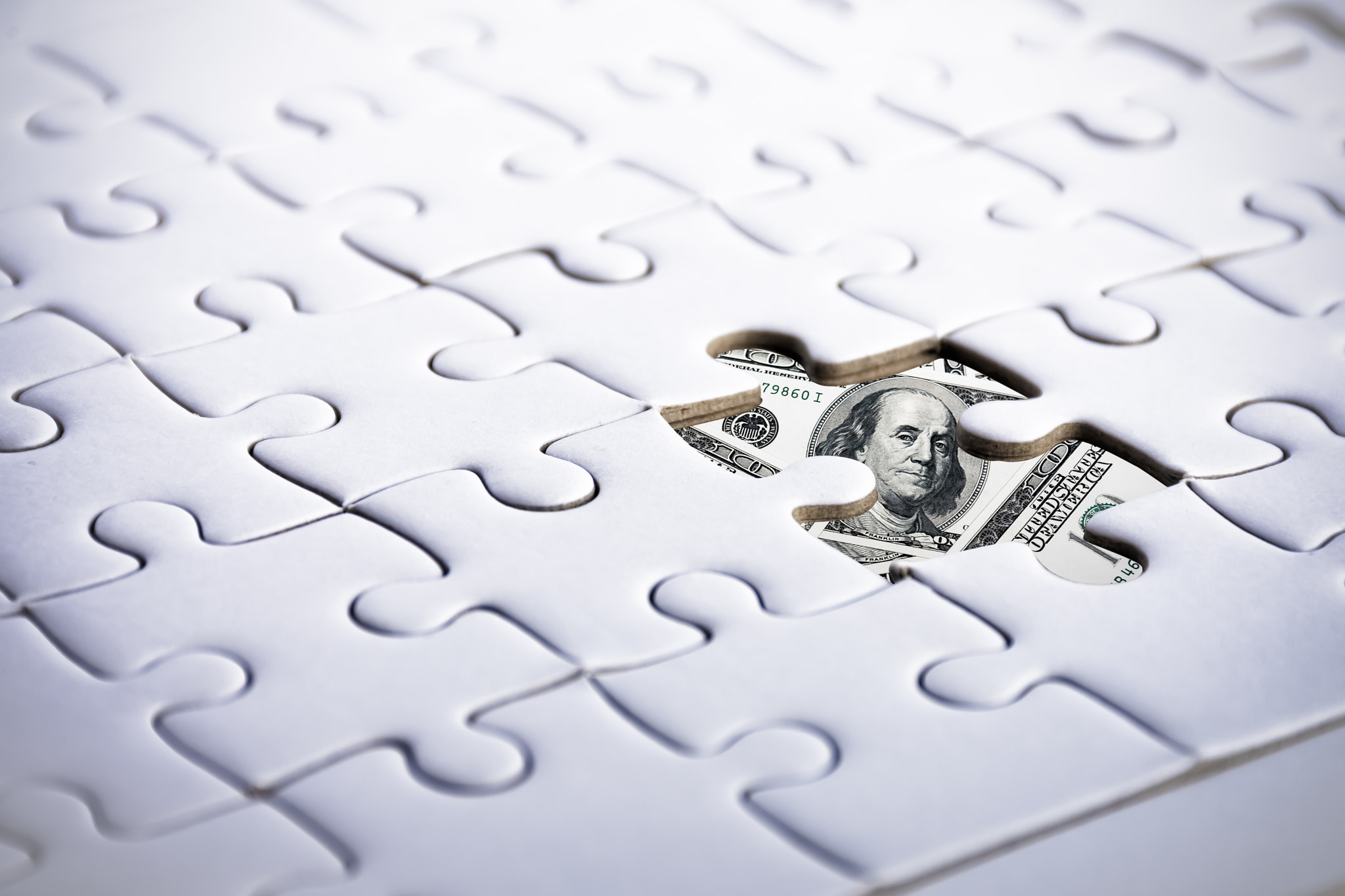 US Dollar behind jigsaw. Business and Financial concept. Marketing and currency theme