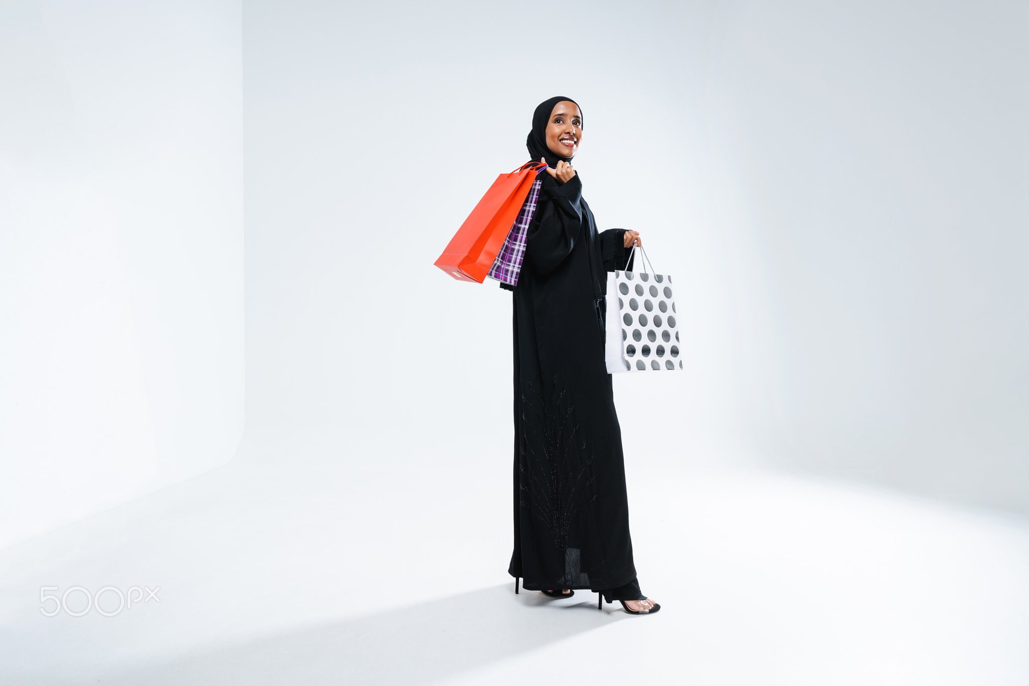 Beautiful arab middle-eastern woman with traditional abaya in studio