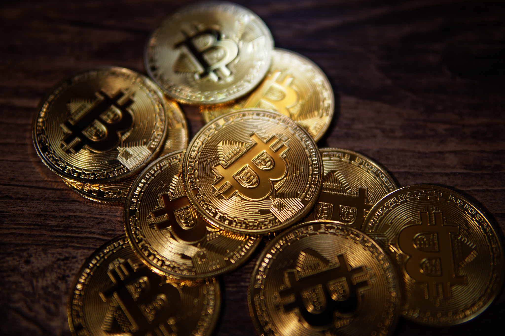 Bitcoin crypto currency isolated on wooden background.