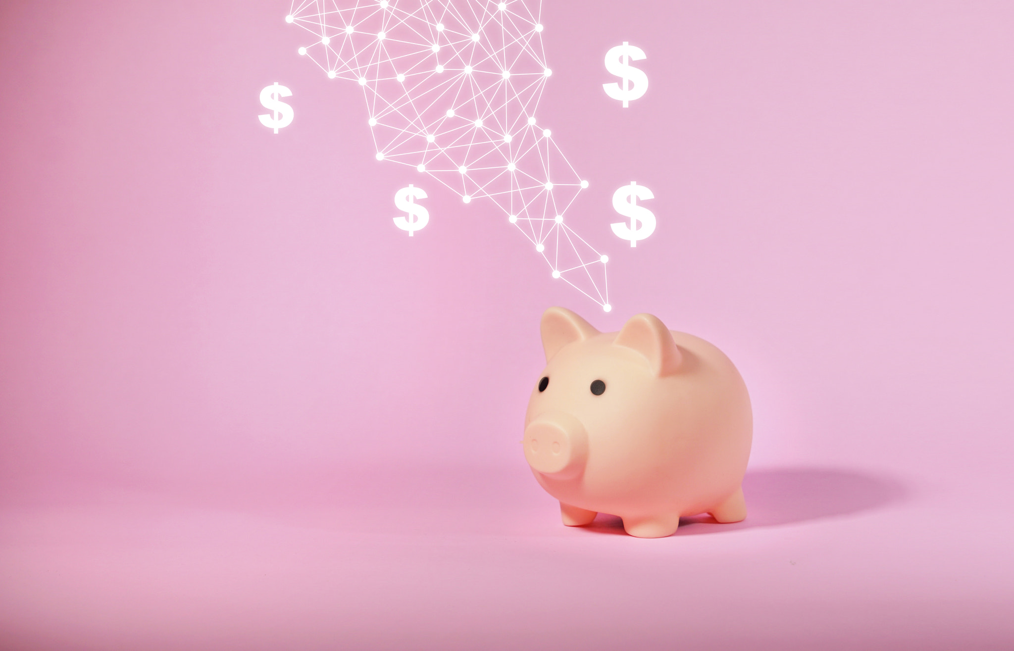 Piggy bank isolated on pink background. Saving money concept.